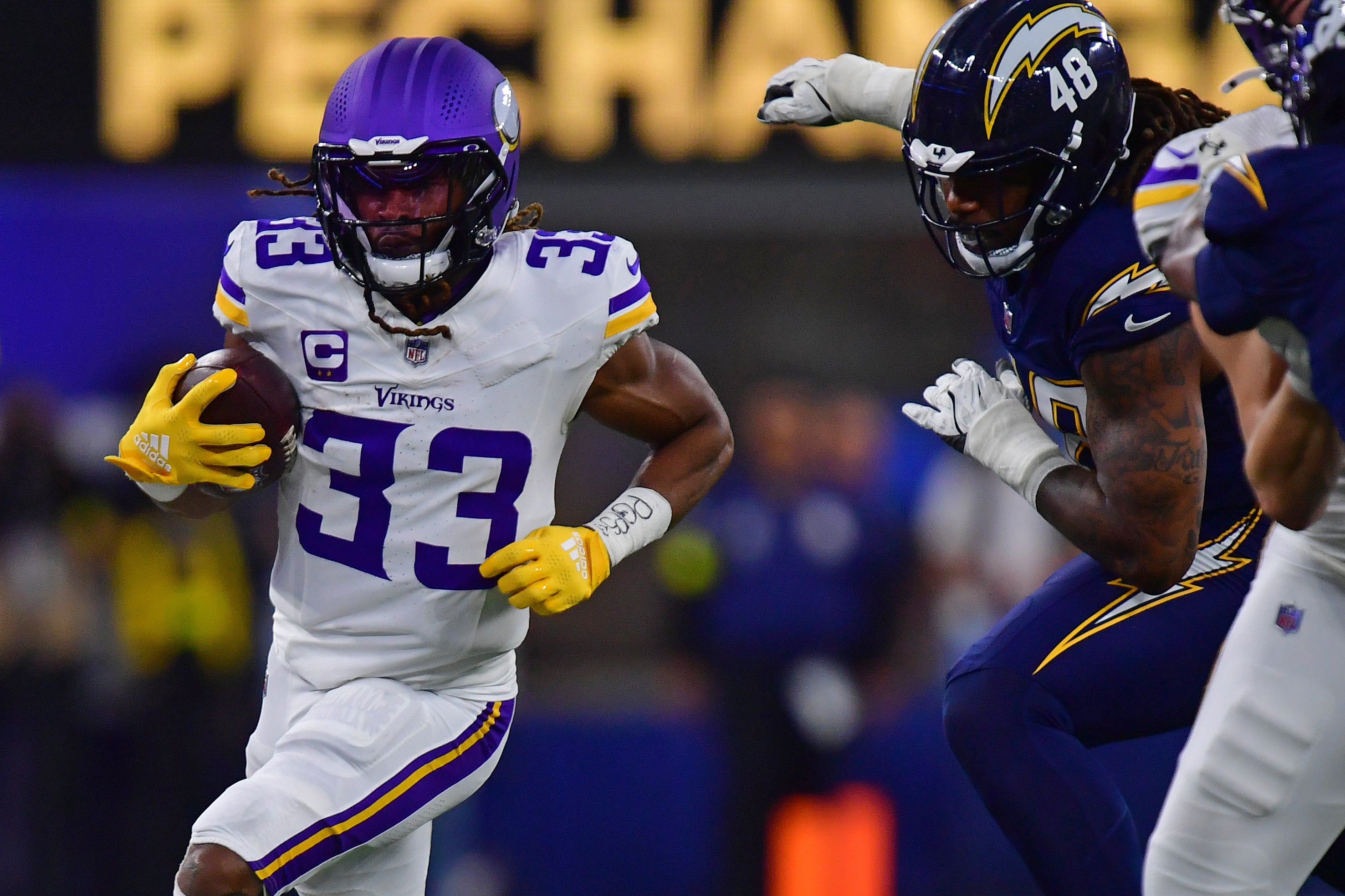 Oct 23, 2025; Inglewood, California, USA; Minnesota Vikings running back Aaron Jones Sr. (33) rushes the ball against the Los Angeles Chargers during the first half at SoFi Stadium.