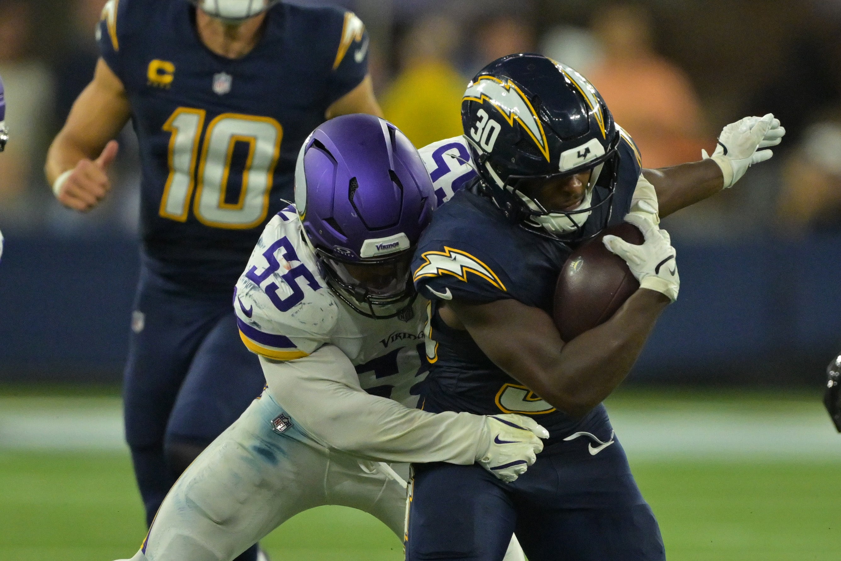 Oct 23, 2025; Inglewood, California, USA; Minnesota Vikings linebacker Eric Wilson (55) tackles Los Angeles Chargers running back Kimani Vidal (30) during the second half at SoFi Stadium.