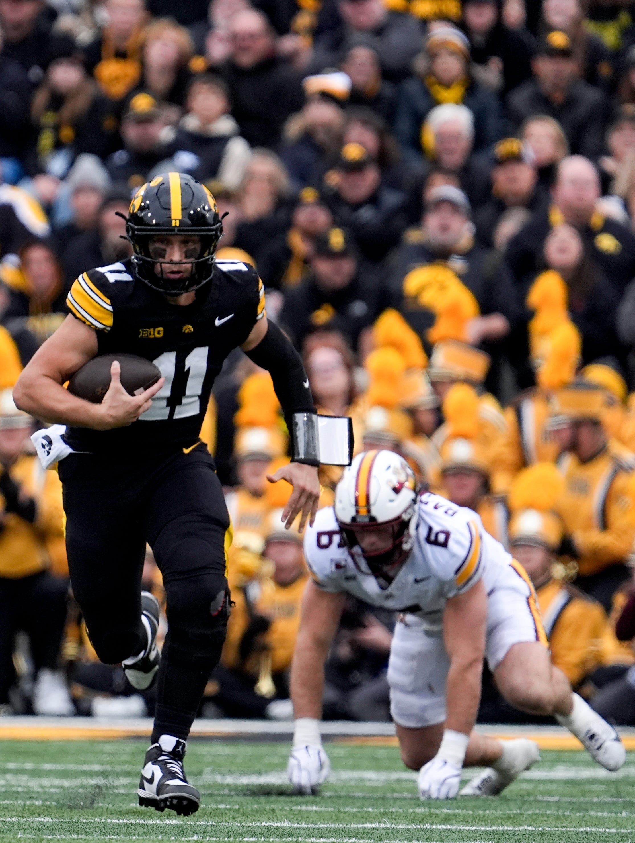Iowa Hawkeyes quarterback Mark Gronowski (11) carries the ball against the Minnesota Golden Gophers Oct. 25, 2025 at Kinnick Stadium in Iowa City, Iowa.