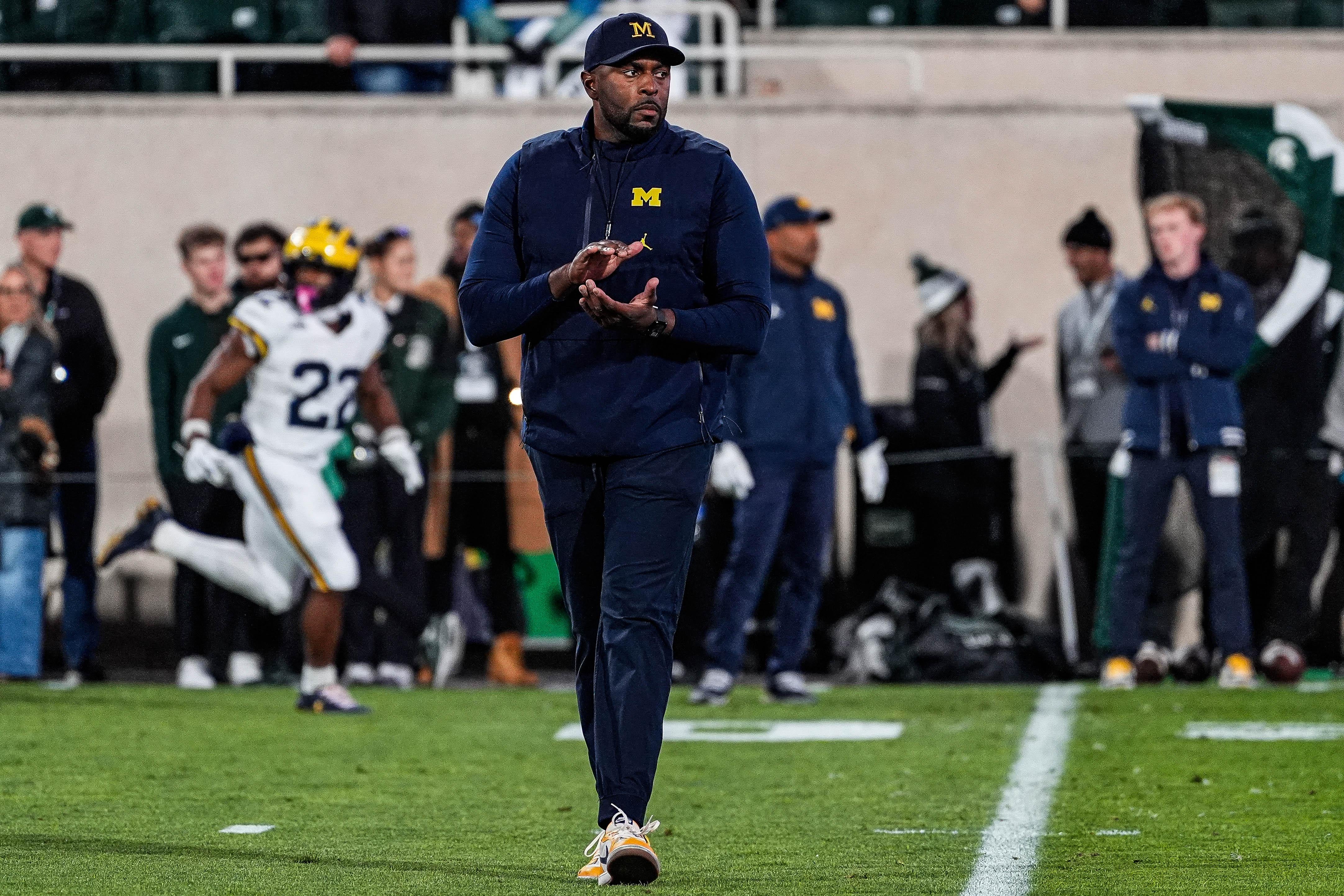 Michigan head coach Sherrone Moore watches warm up at Spartan Stadium in East Lansing on Saturday, October 25, 2025.