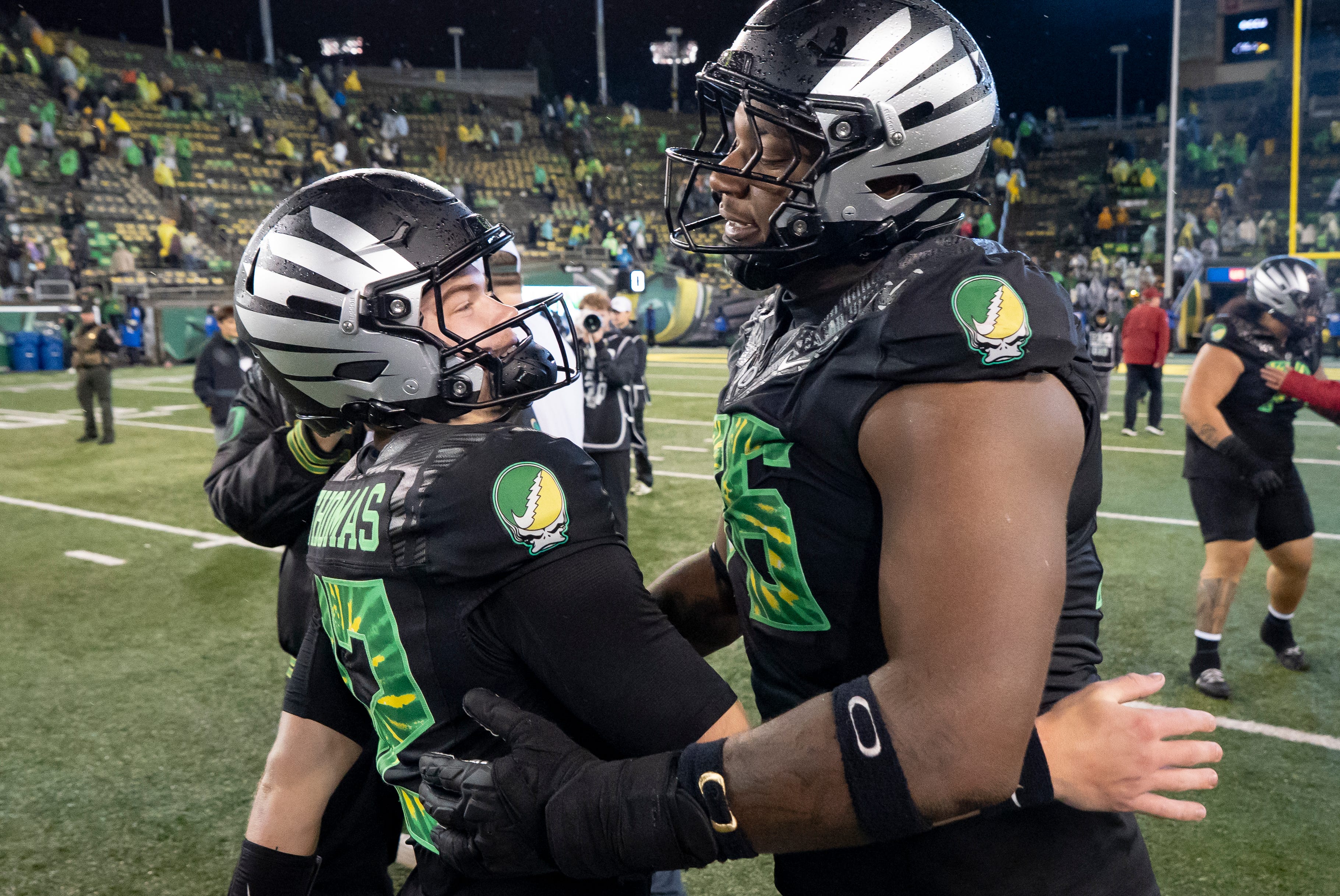 Oregon offensive lineman Isaiah World, right, congratulates Oregon quarterback Brock Thomas as the Oregon Ducks host the Wisconsin Badgers on Oct. 25, 2025, at Autzen Stadium in Eugene, Oregon.