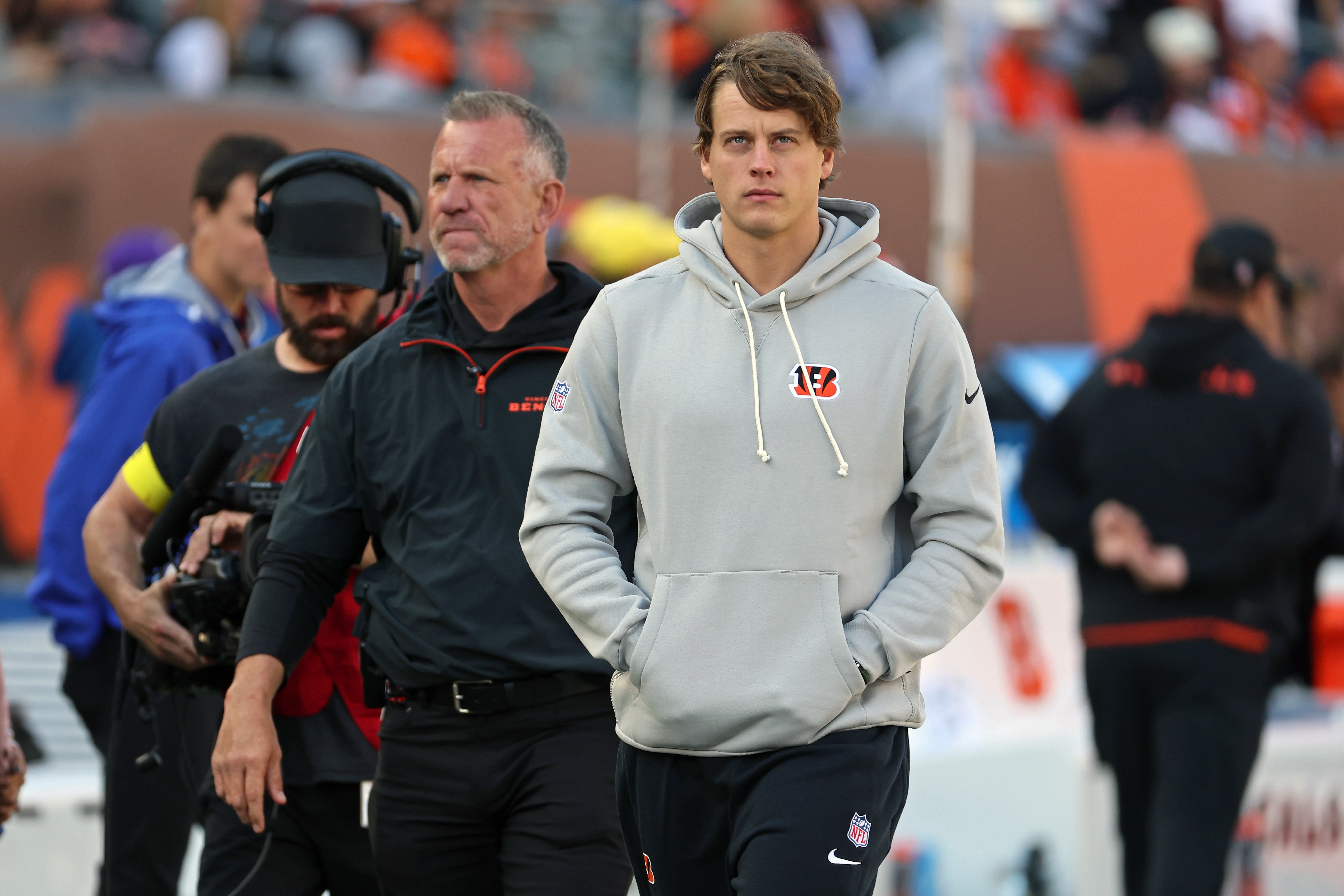 Oct 26, 2025; Cincinnati, Ohio, USA; Cincinnati Bengals quarterback Joe Burrow (9) looks on on the sidelines during the second quarter against the New York Jets at Paycor Stadium.