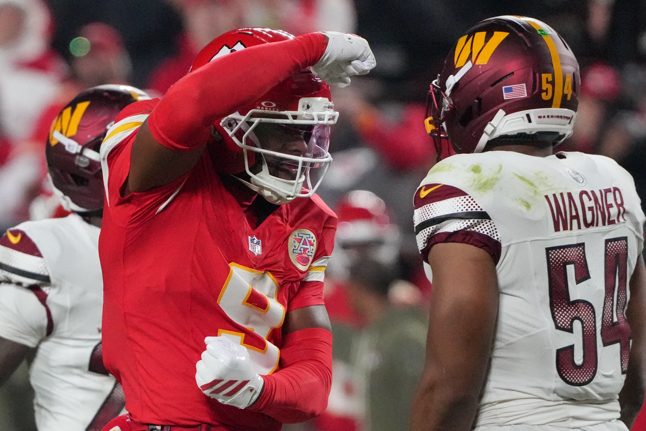 Kansas City Chiefs wide receiver Juju Smith-Schuster (9) celebrates after a play as Washington Commanders middle linebacker Bobby Wagner (54) looks on