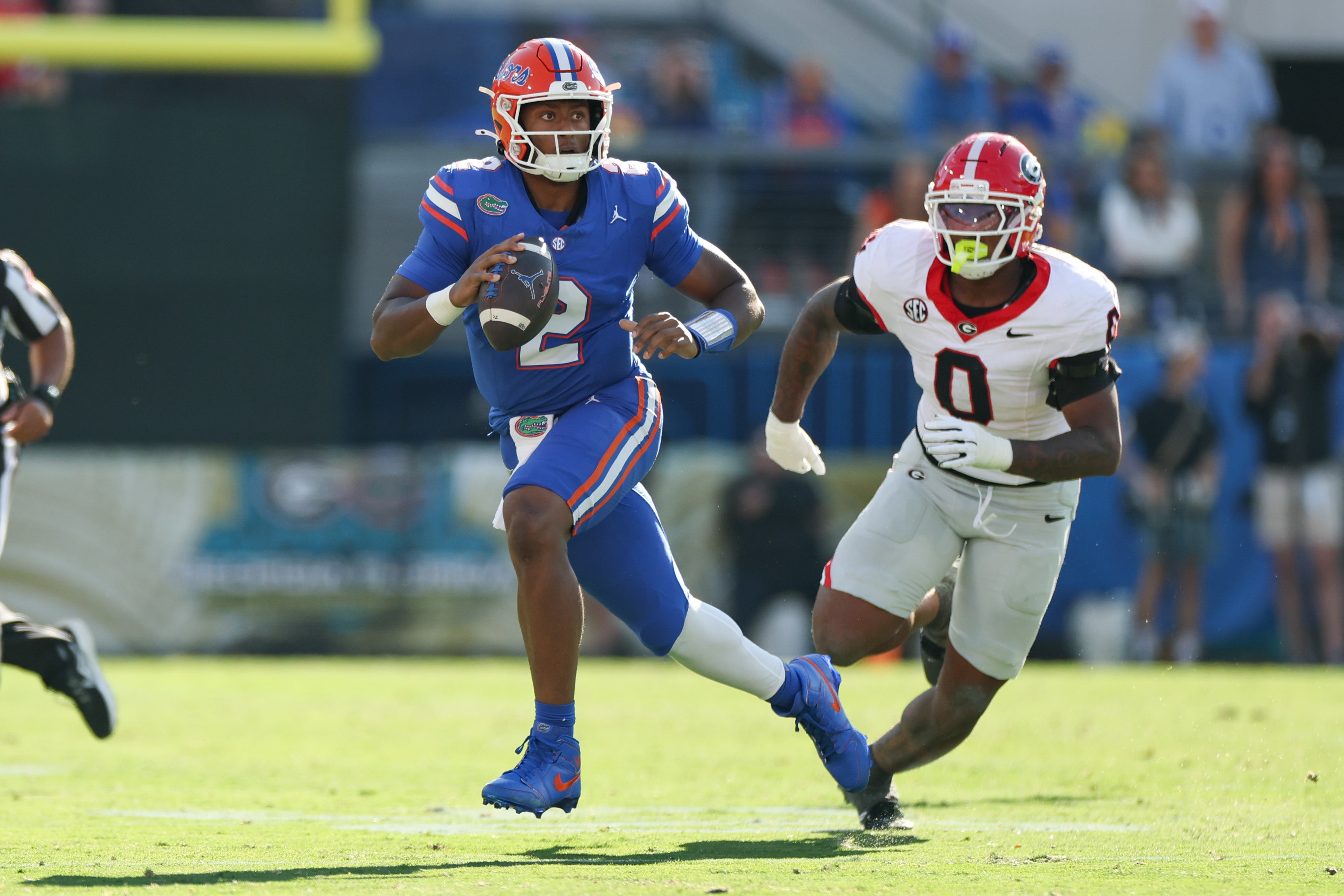 Nov 1, 2025; Jacksonville, Florida, USA; Florida Gators quarterback DJ Lagway (2) evades Georgia Bulldogs outside linebacker Gabe Harris Jr. (0) in the first quarter against the Georgia Bulldogs at EverBank Stadium.