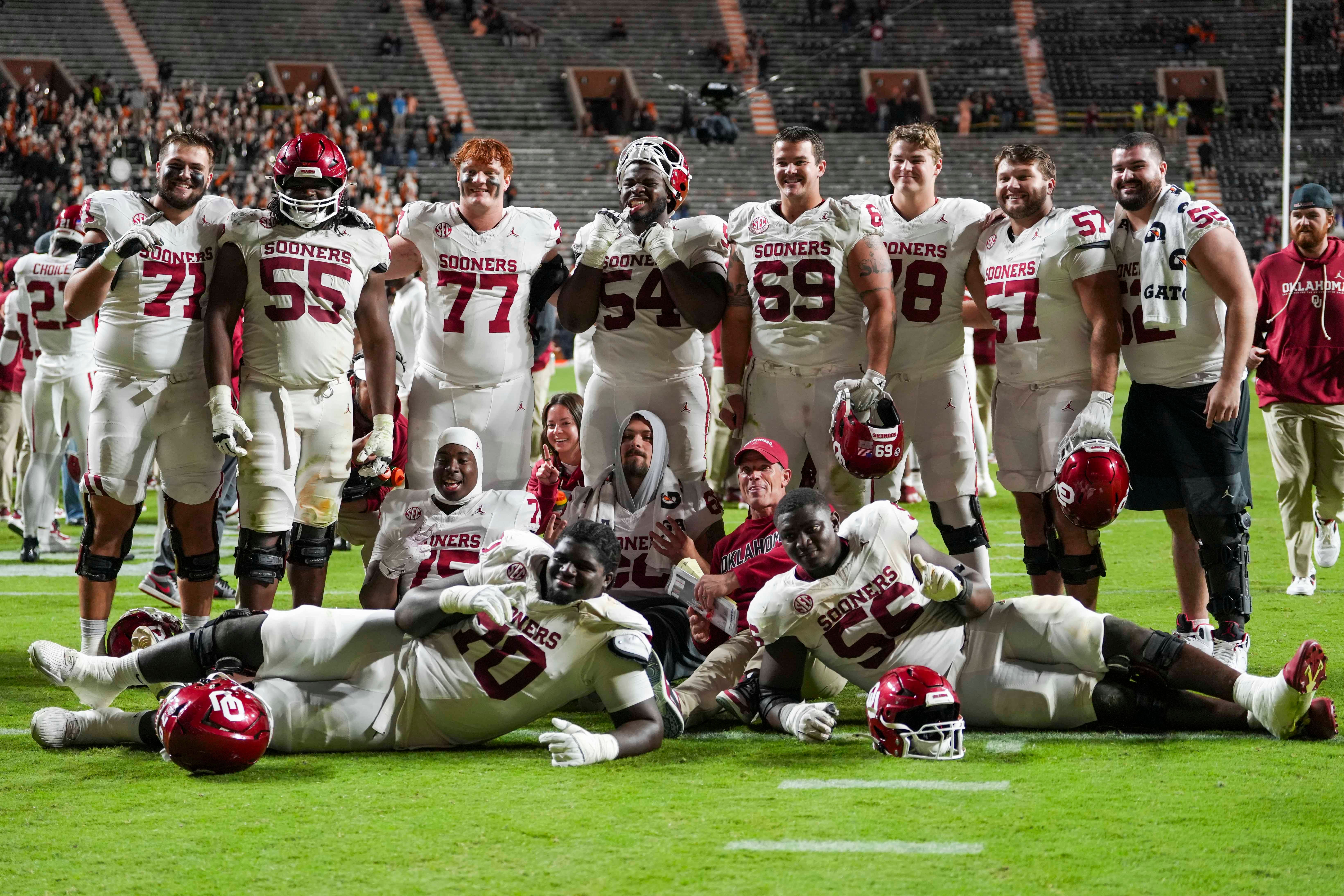 The Oklahoma football team pose for a picture with Oklahoma coach Brent Venables after winning a NCAA football game between the Tennessee Volunteers and Oklahoma Sooners at Neyland Stadium in Knoxville, Tenn., on November 1, 2025.