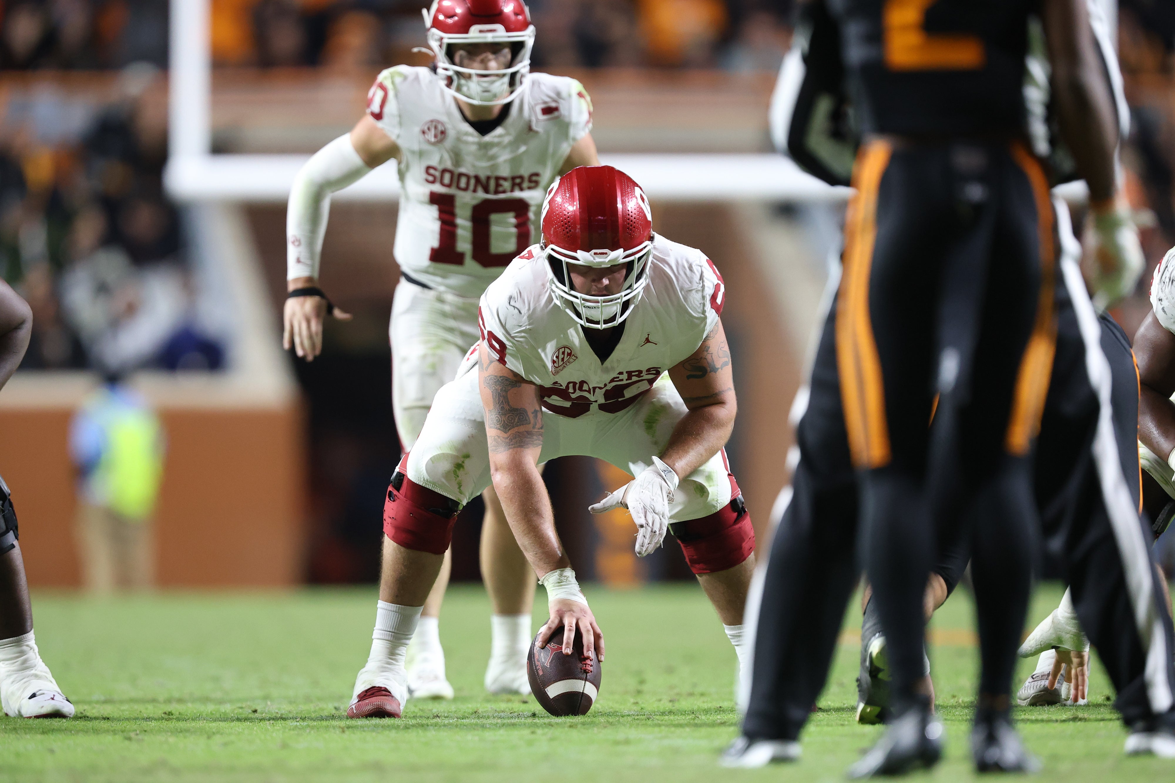 Nov 1, 2025; Knoxville, Tennessee, USA; Oklahoma Sooners offensive lineman Jake Maikkula (69) sets to snap the ball to quarterback John Mateer (10) during the second half against the Tennessee Volunteers at Neyland Stadium.