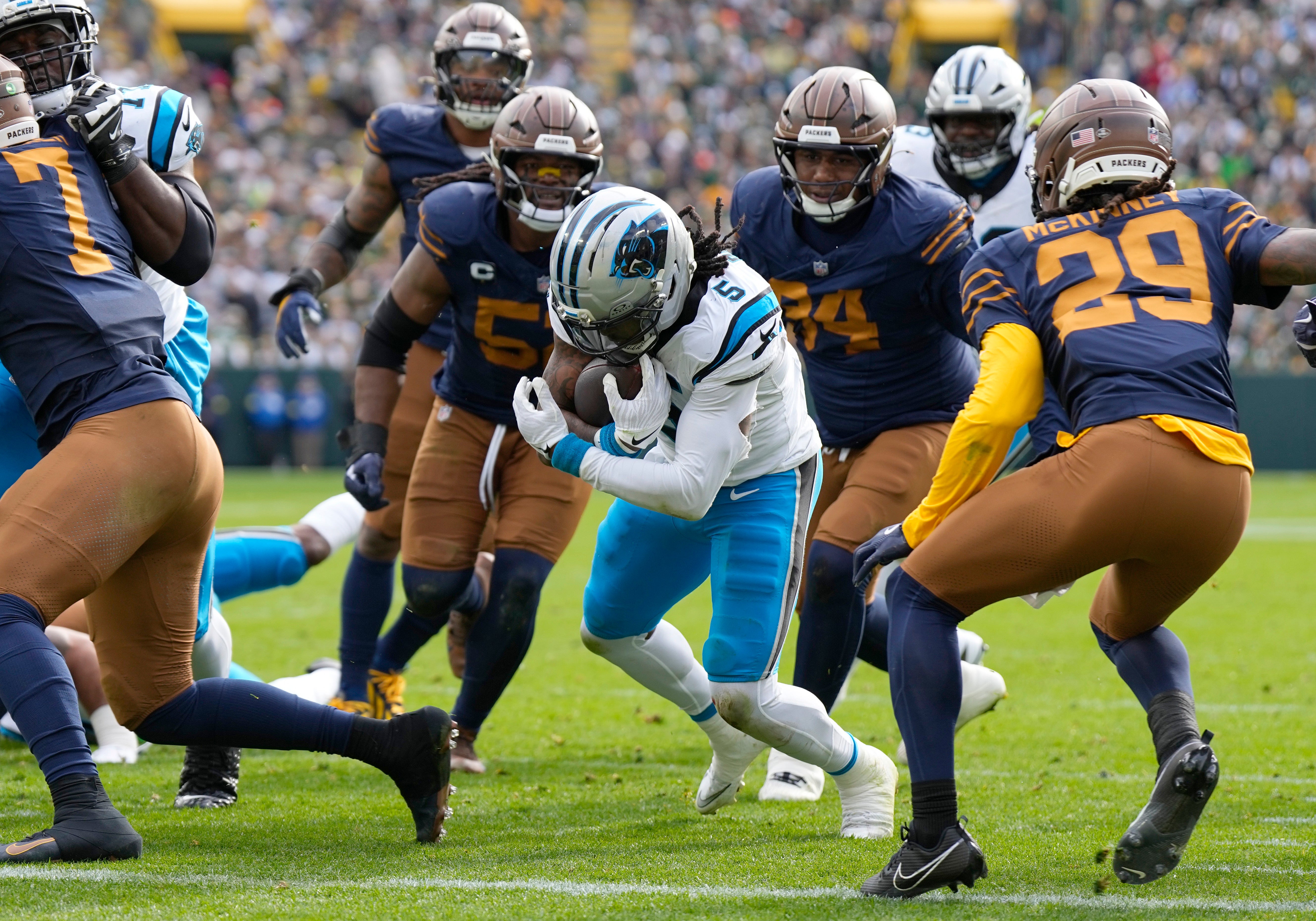 Nov 2, 2025; Green Bay, Wisconsin, USA; Carolina Panthers running back Rico Dowdle (5) scores a touchdown during the first half against the Green Bay Packers at Lambeau Field.