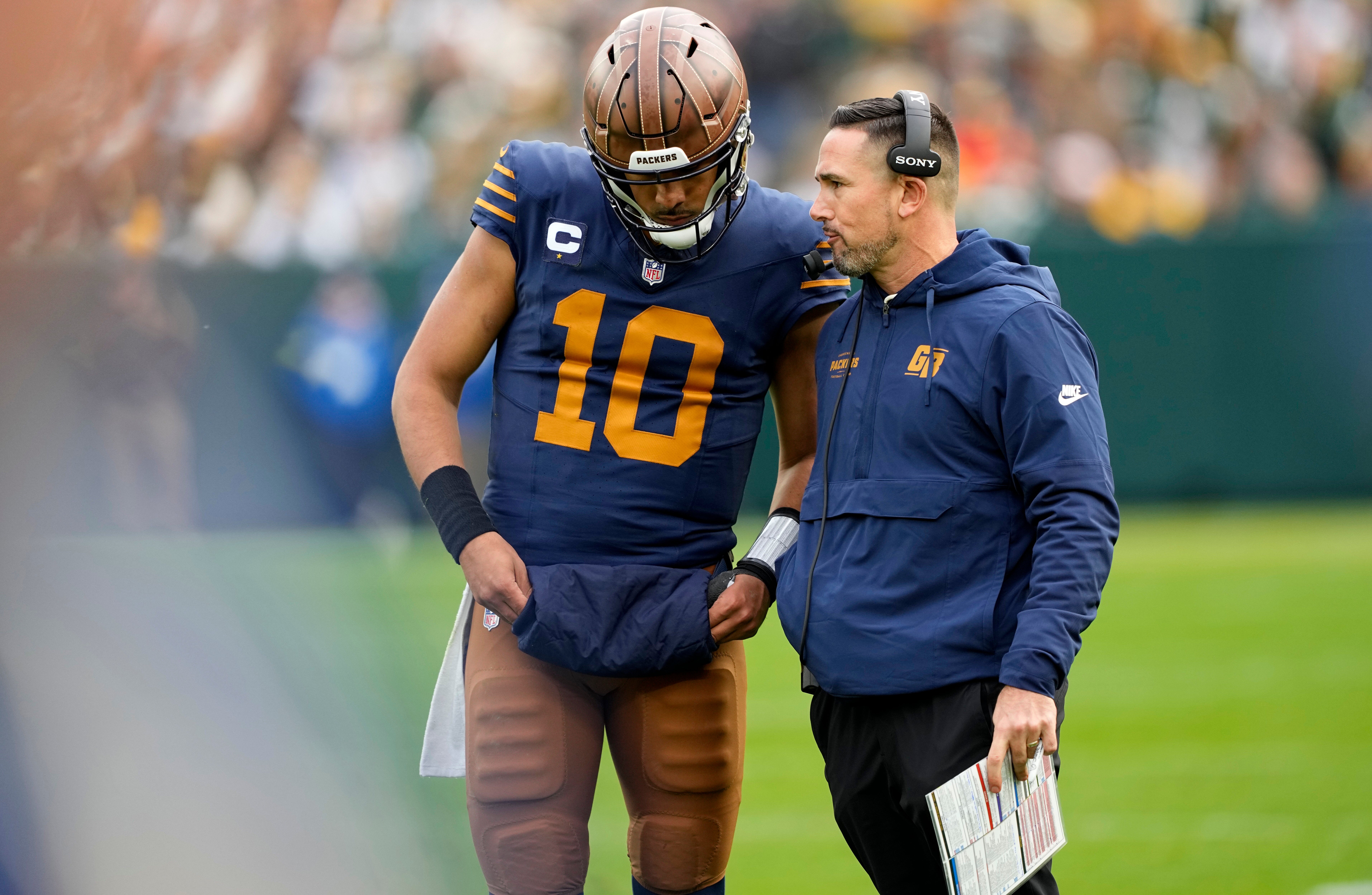 Nov 2, 2025; Green Bay, Wisconsin, USA; Green Bay Packers head coach Matt LaFleur talks to quarterback Jordan Love (10) during the second half against the Carolina Panthers at Lambeau Field.