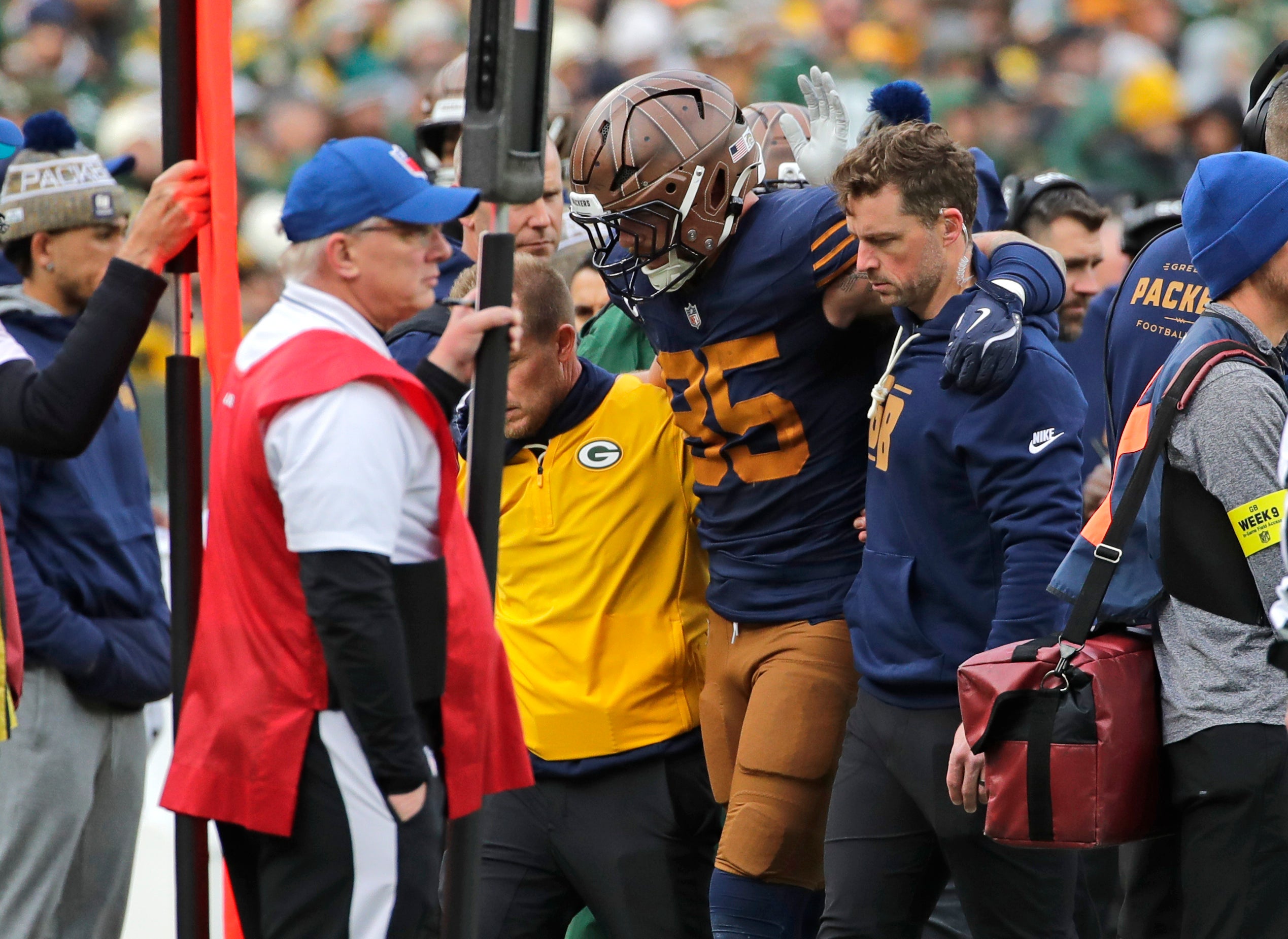 Nov 2, 2025; Green Bay, Wisconsin, USA; Green Bay Packers tight end Tucker Kraft (85) is assisted off the field after getting injured against the Carolina Panthers during their football game at Lambeau Field.