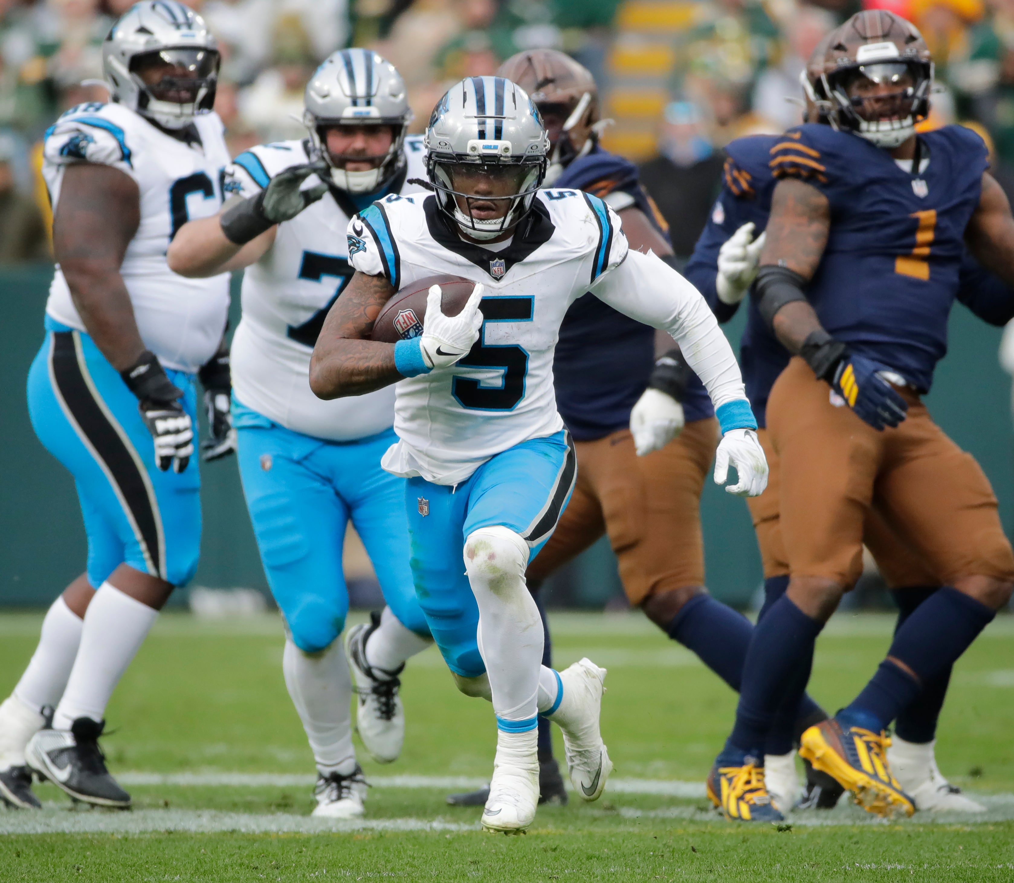 Nov 2, 2025; Green Bay, Wisconsin, USA; Carolina Panthers running back Rico Dowdle (5) breaks away for a long gain with less than a minute left in the game against the Green Bay Packers during their football game at Lambeau Field.