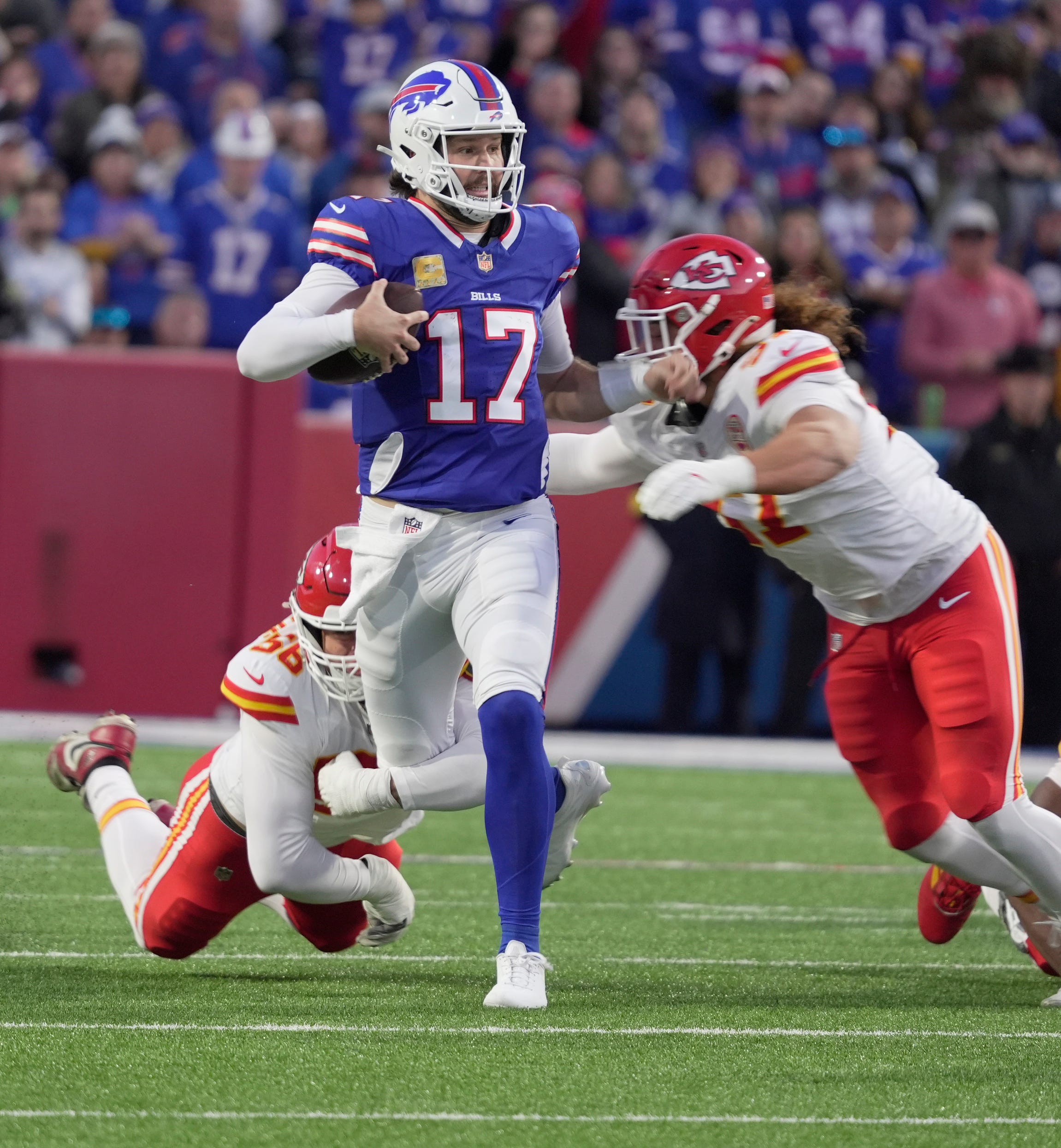 Kansas City Chiefs defensive end George Karlaftis takes down Buffalo Bills quarterback Josh Allen
