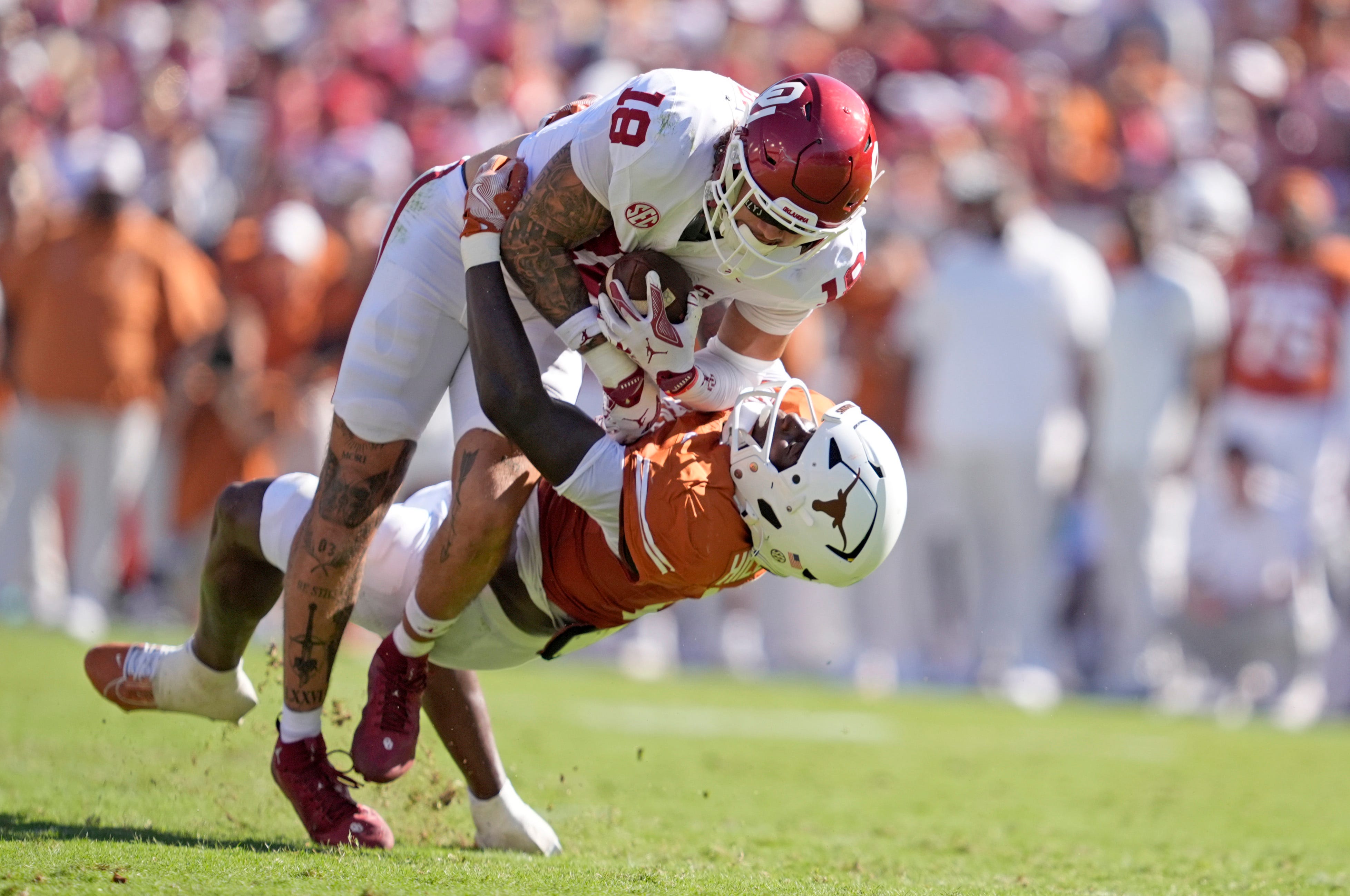 Oklahoma Sooners tight end Kaden Helms (18) looks to get by Texas Longhorns defensive back Jelani McDonald (4) in the first half of the Red River Rivalry college football game between the University of Oklahoma Sooners and the Texas Longhorn at the Cotton Bowl Stadium in Dallas, Texas, Saturday, Oct. 11, 2025.