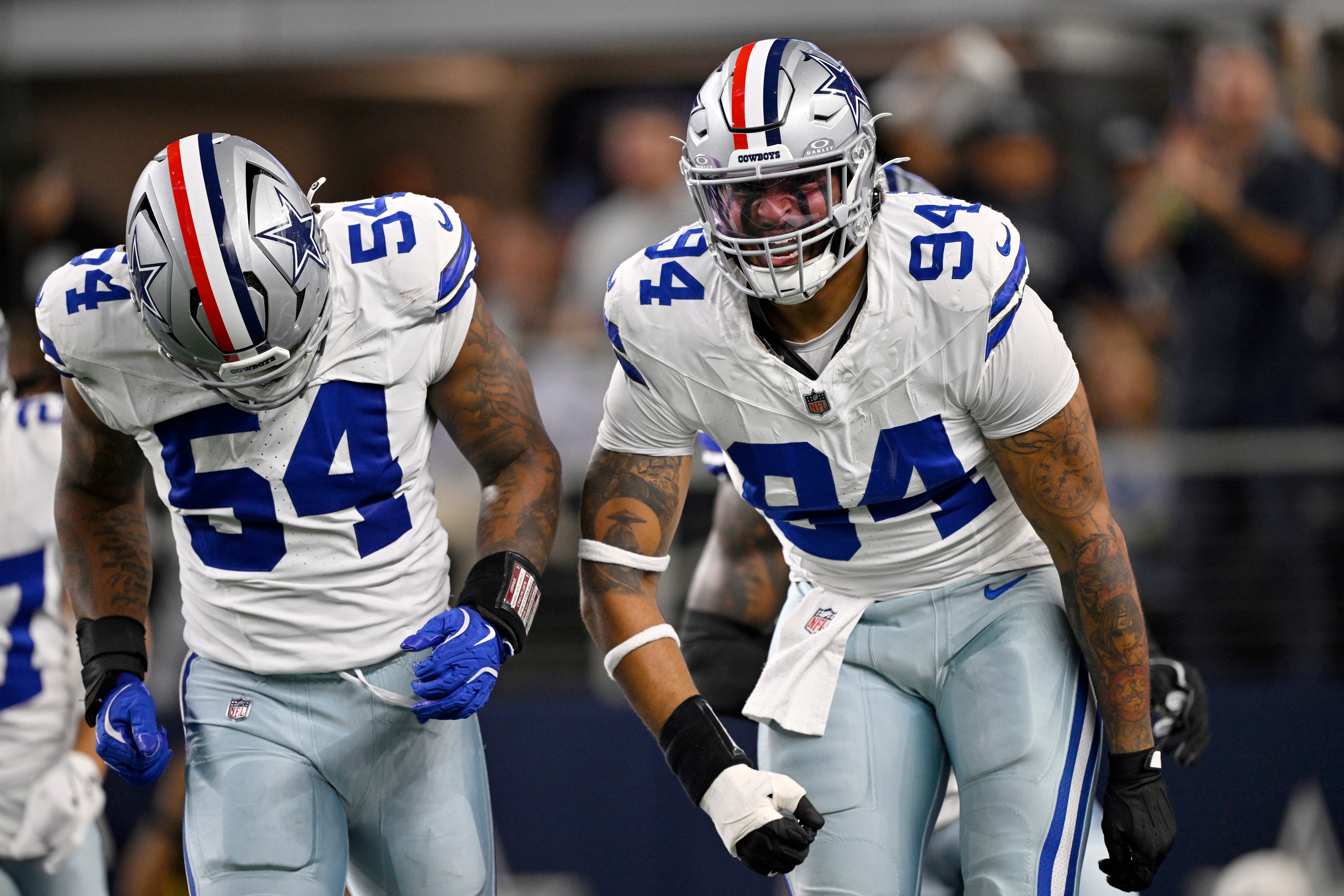 Dallas Cowboys defensive end Marshawn Kneeland (94) celebrates with defensive end Sam Williams (54) after recovering a blocked punt for a touchdown against the Arizona Cardinals in the first half at AT&T Stadium.