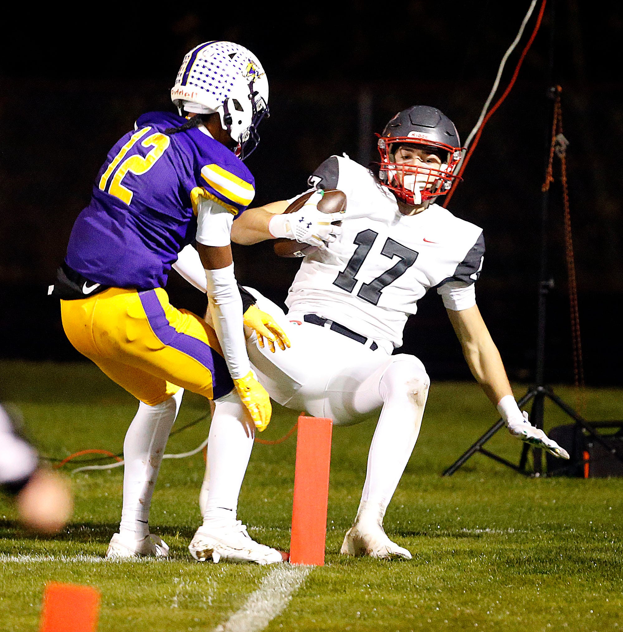 Toledo Central Catholic High School's Preston Fryzel (17) is unable to come down in bounds for a touchdown as Lexington High School's Dantrell Hughes (12) defends during OHSAA Division III regional quarterfinal high school football action Friday, Nov. 7, 2025 at Colonel Crawford High School. TOM E. PUSKAR/MANSFIELD NEWS JOURNAL