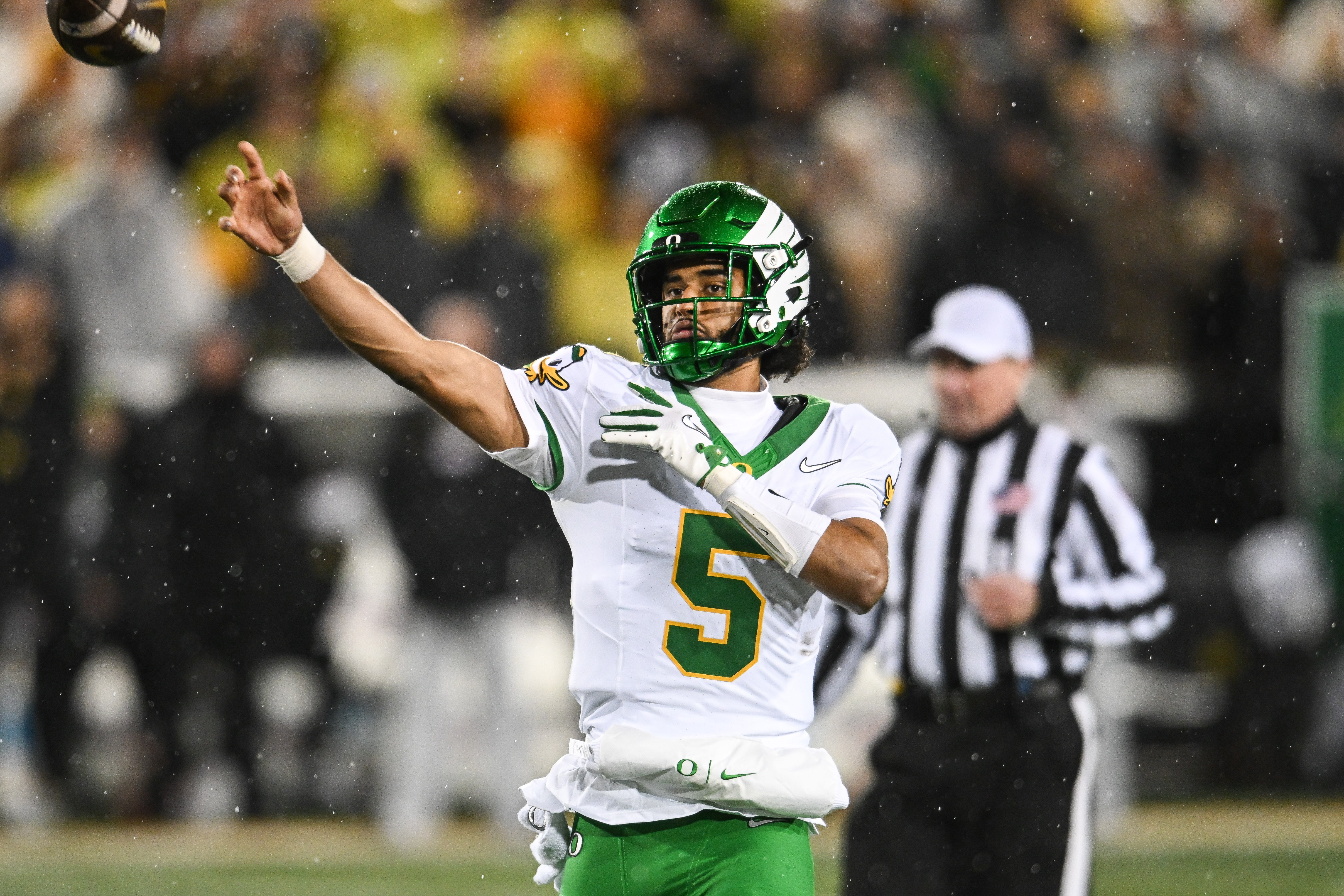 Nov 8, 2025; Iowa City, Iowa, USA; Oregon Ducks quarterback Dante Moore (5) throws a pass against the Iowa Hawkeyes during the fourth quarter at Kinnick Stadium. Mandatory Credit: Jeffrey Becker-Imagn Images