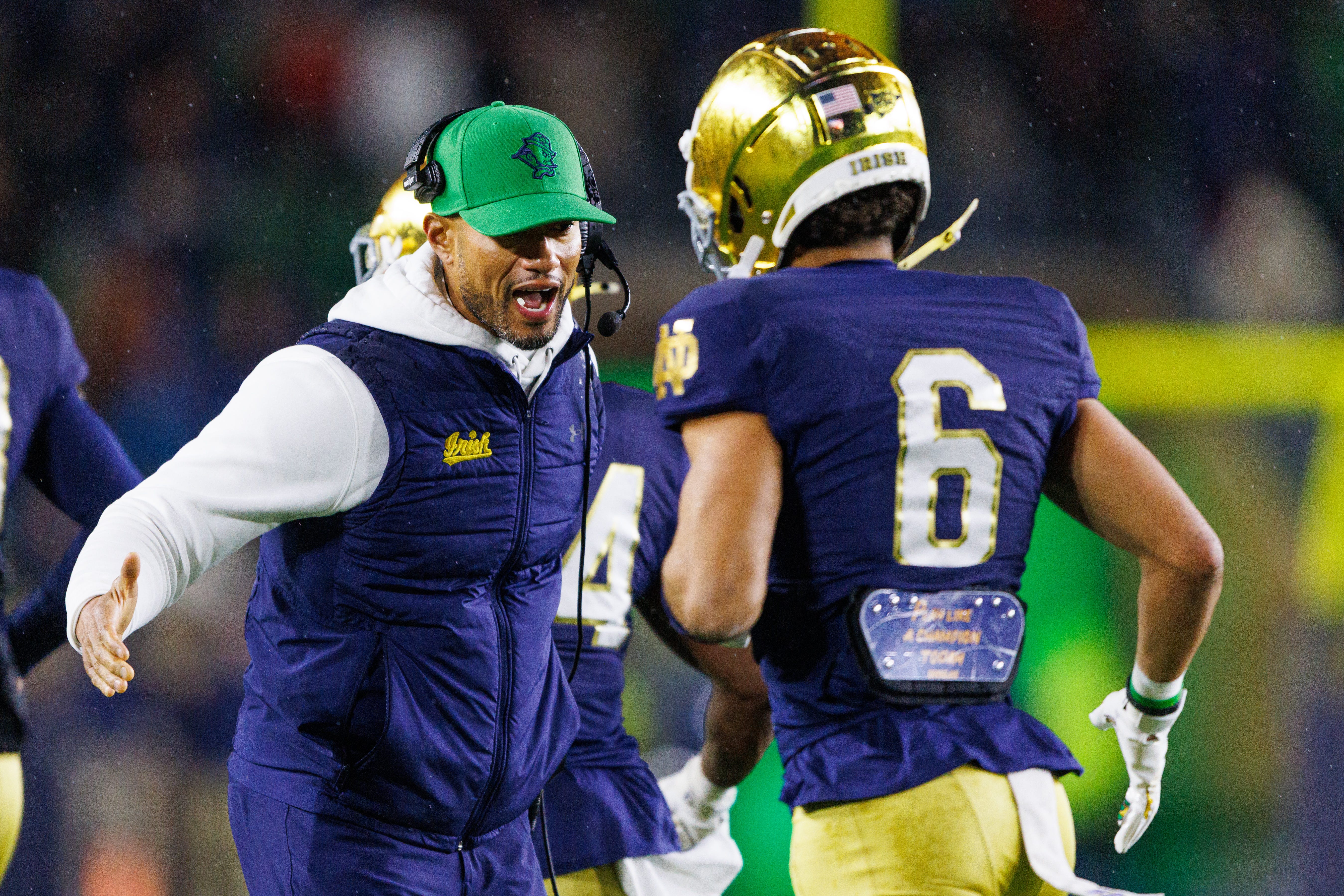 Notre Dame head coach Marcus Freeman, left, celebrates with wide receiver Jordan Faison (6) after a touchdown during the first half of a NCAA football game against Navy at Notre Dame Stadium on Saturday, Nov. 8, 2025, in South Bend.