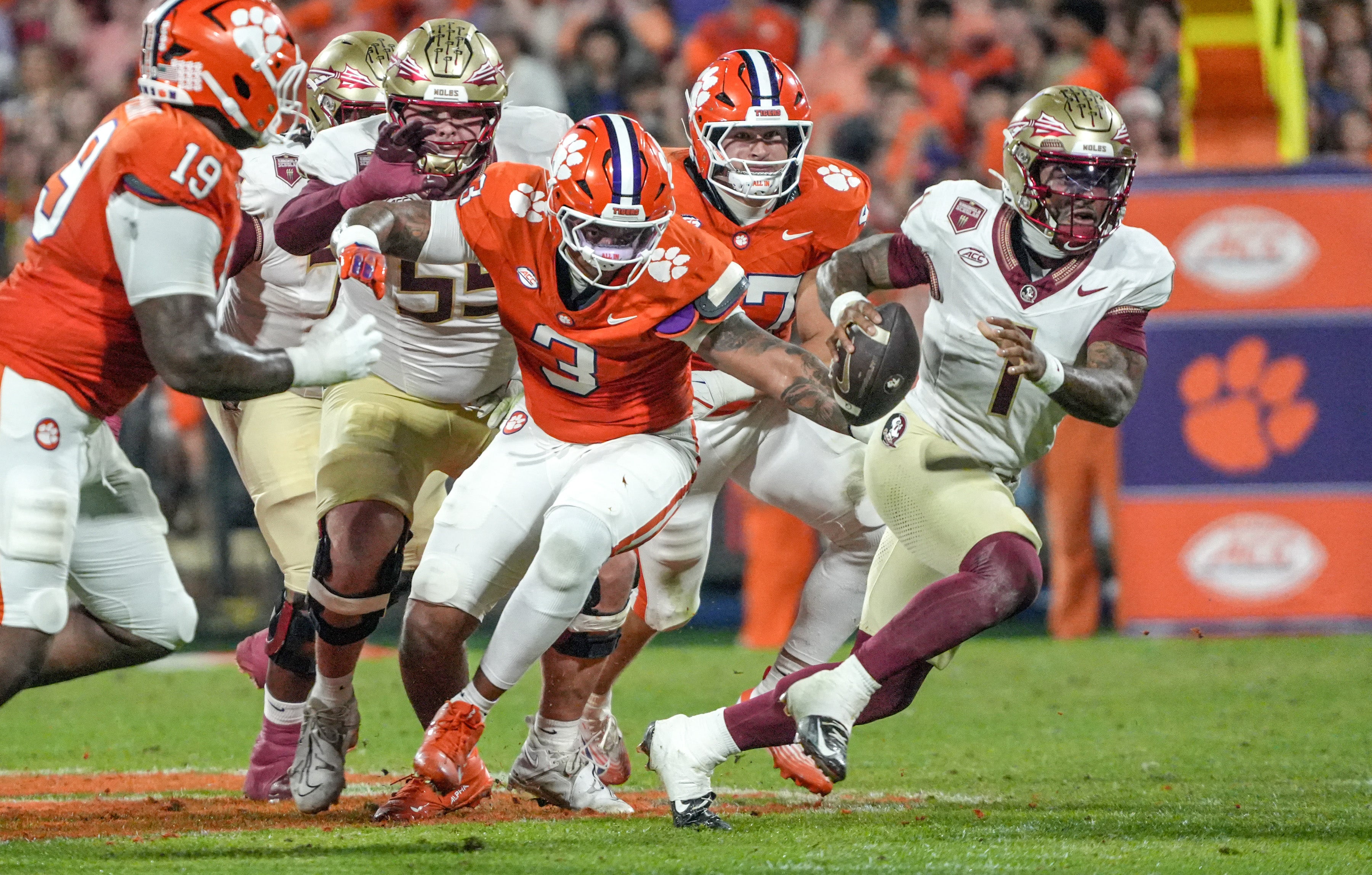 Nov 8, 2025; Clemson, South Carolina, USA; Florida State Seminoles quarterback Tommy Castellanos (1) runs near Clemson Tigers defensive end T.J. Parker (3) during the second quarter at Memorial Stadium.