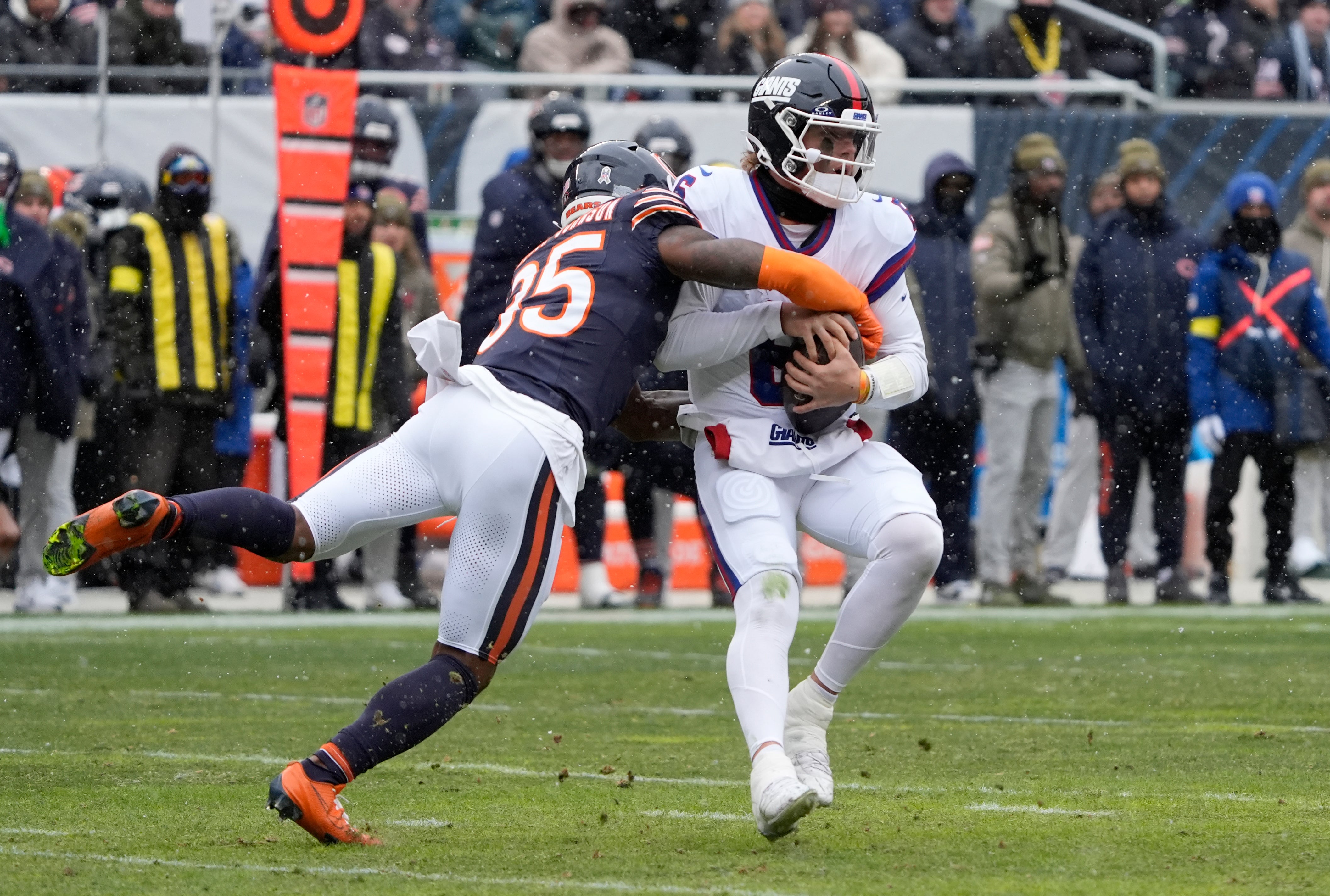 Nov 9, 2025; Chicago, Illinois, USA; Chicago Bears safety C.J. Gardner-Johnson (35) sacks New York Giants quarterback Jaxson Dart (6) during the first half at Soldier Field.