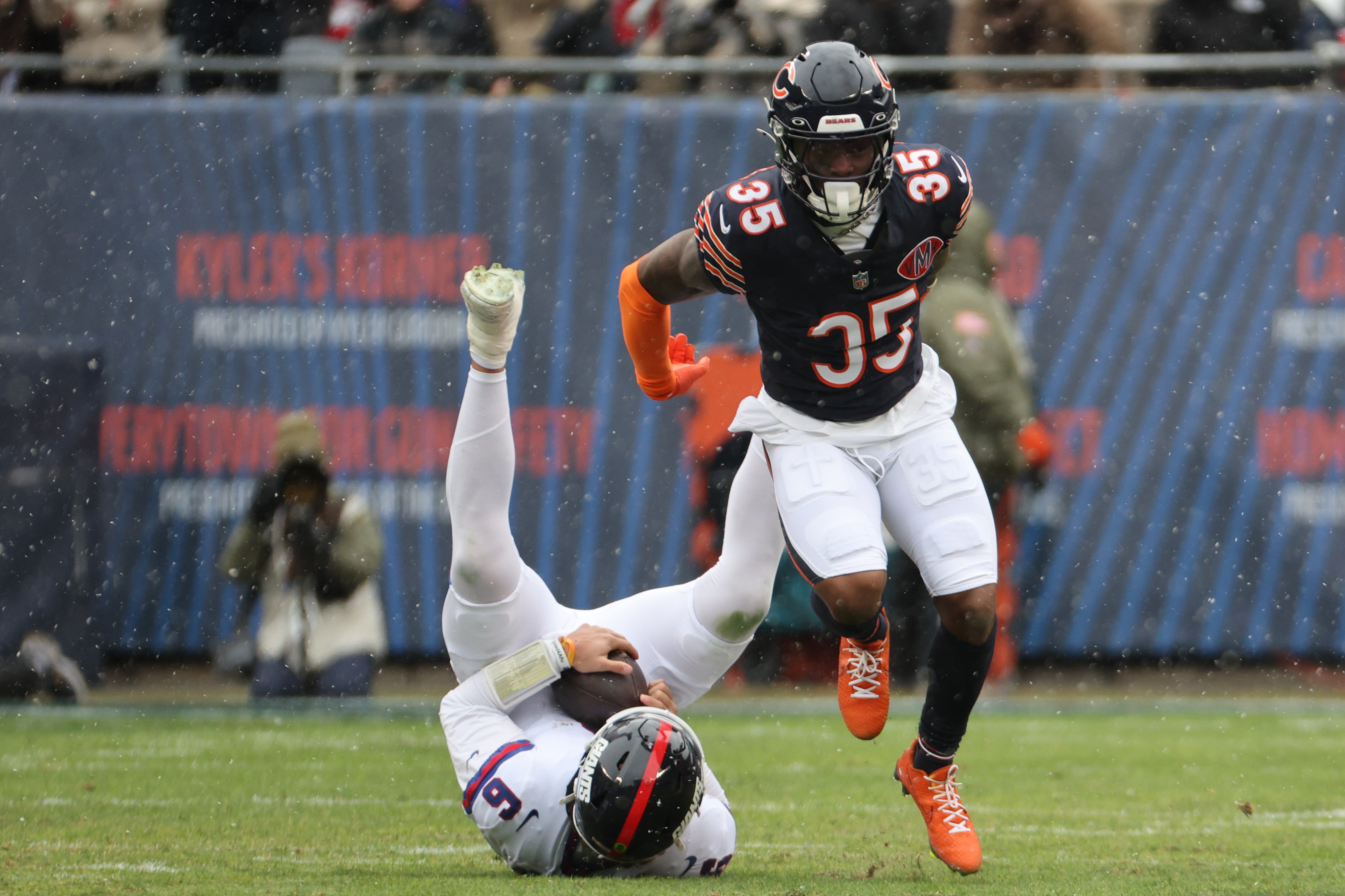 Nov 9, 2025; Chicago, Illinois, USA; Chicago Bears defensive back C.J. Gardner-Johnson (35) sacks New York Giants quarterback Jaxson Dart (6) during the first half at Soldier Field.