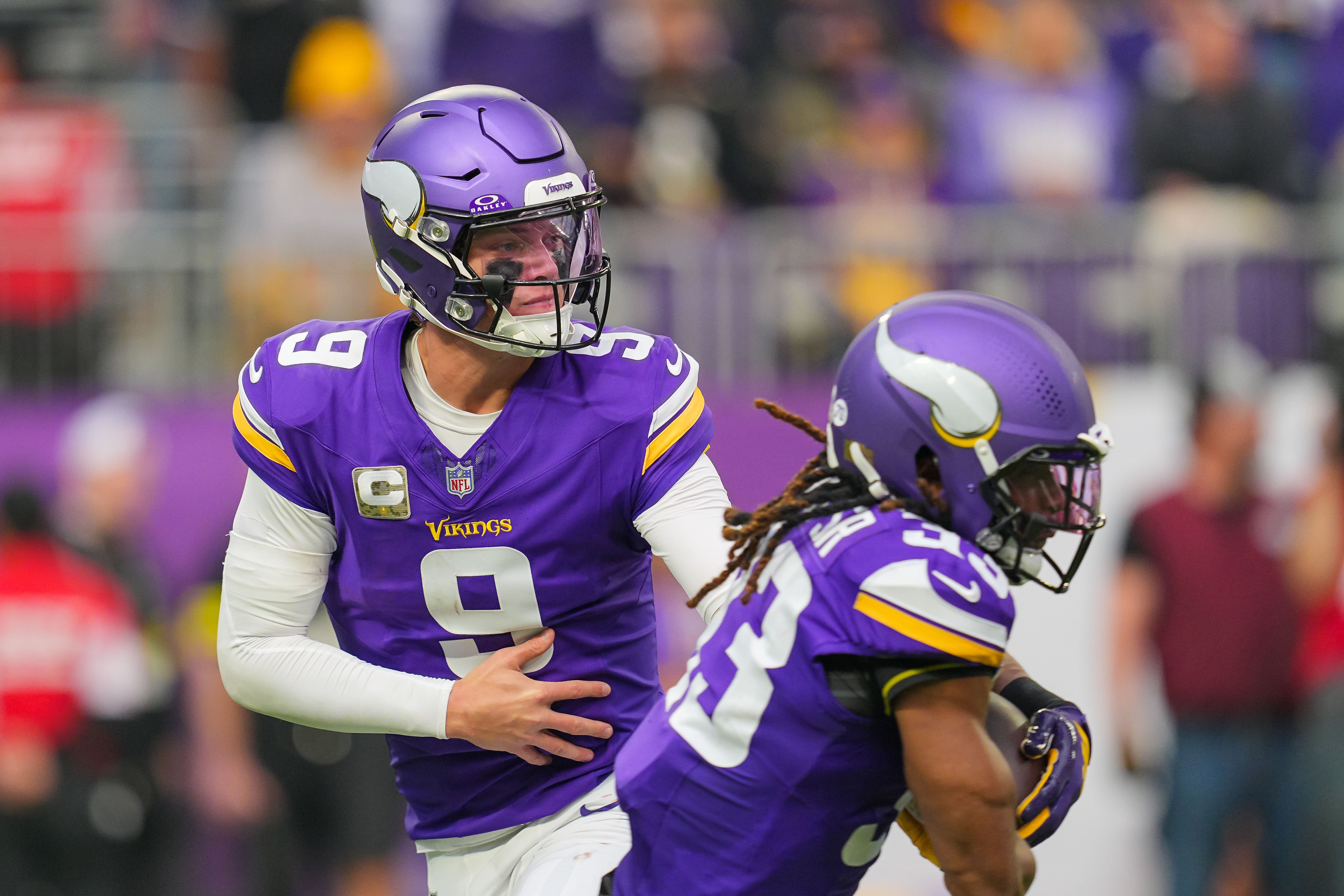 Nov 9, 2025; Minneapolis, Minnesota, USA; Minnesota Vikings quarterback J.J. McCarthy (9) hands the ball off to running back Aaron Jones Sr. (33) against the Baltimore Ravens in the second quarter at U.S. Bank Stadium.