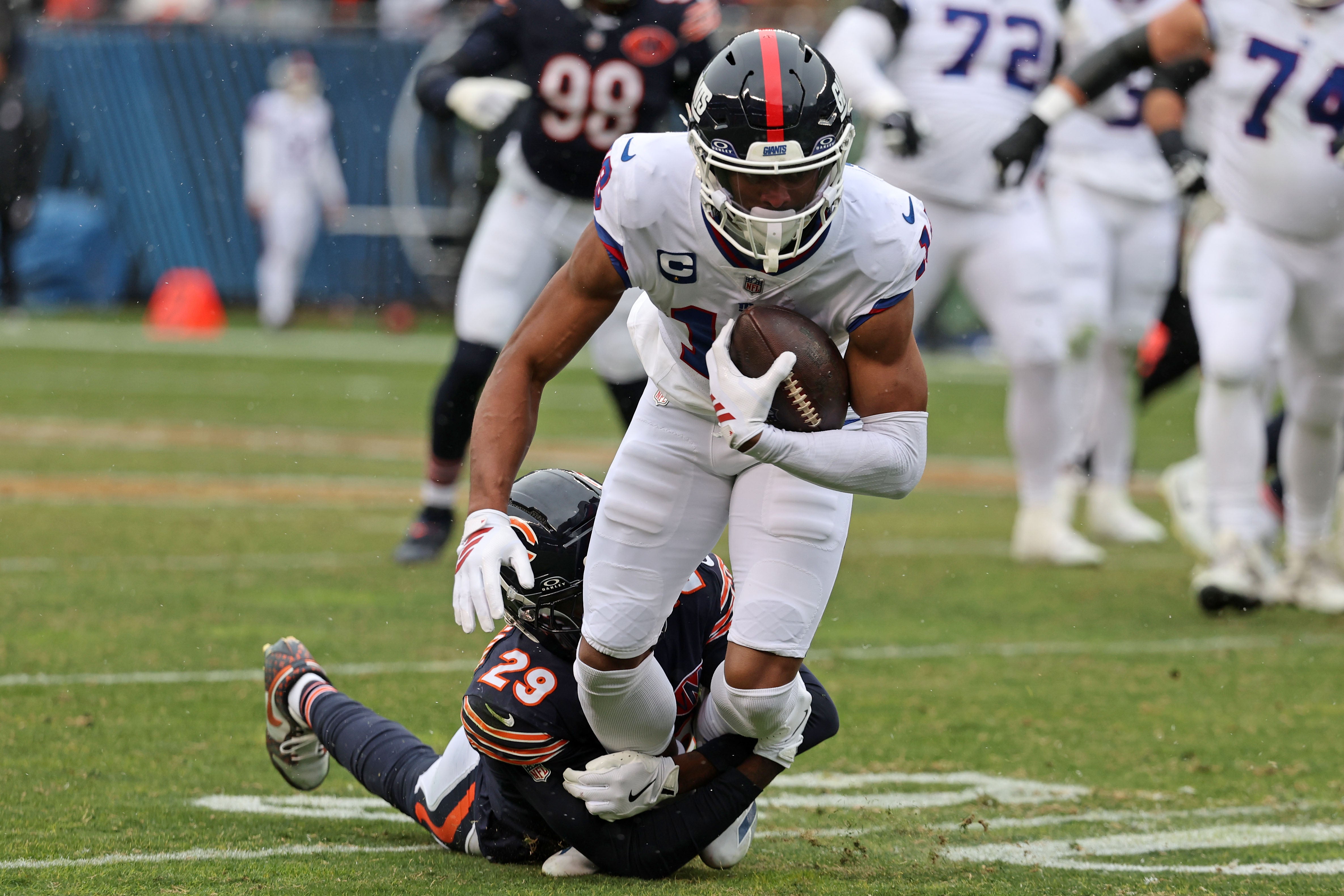 Nov 9, 2025; Chicago, Illinois, USA; New York Giants wide receiver Darius Slayton (18) makes a catch against Chicago Bears cornerback Tyrique Stevenson (29) during the second half at Soldier Field.