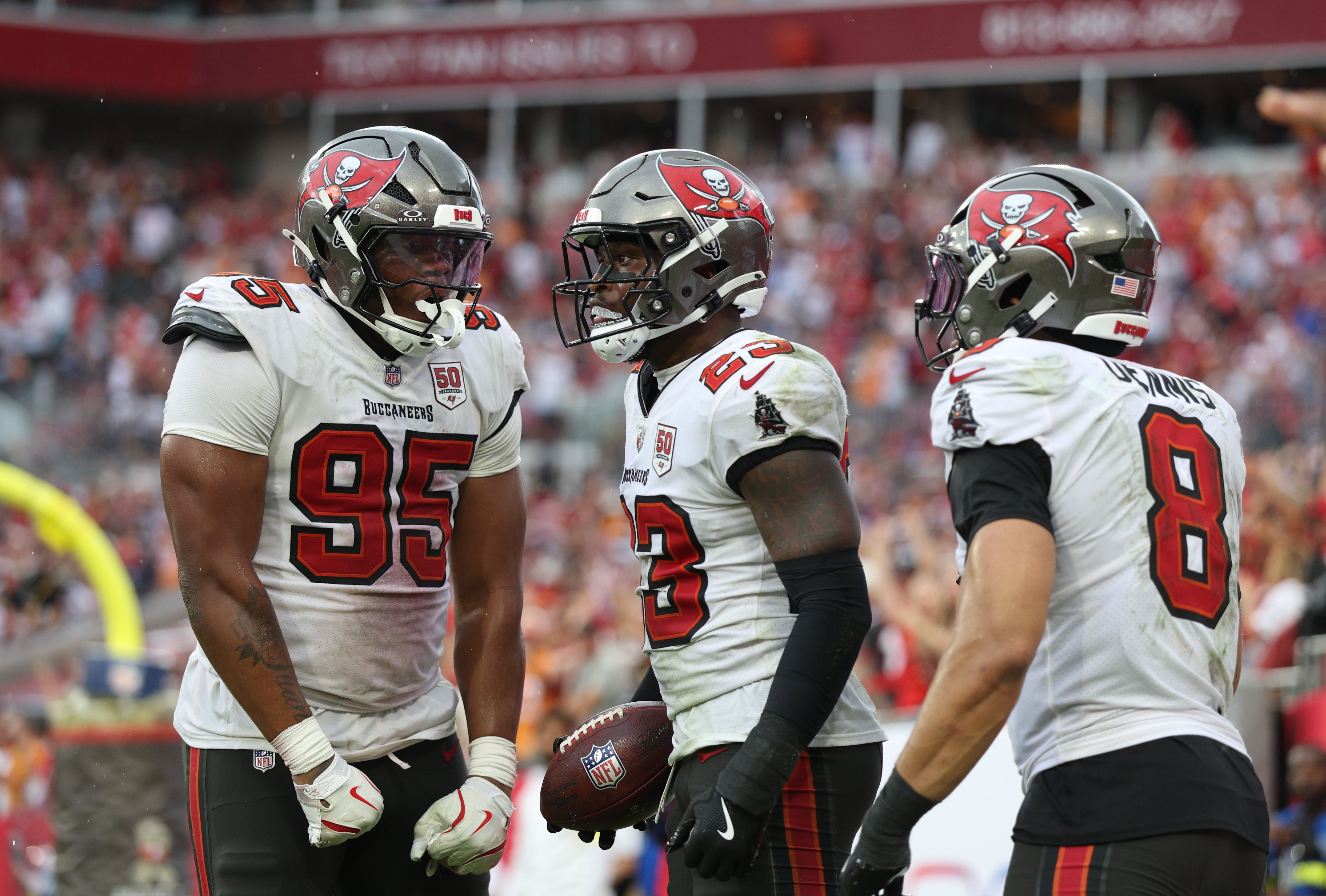 Nov 9, 2025; Tampa, Florida, USA; Tampa Bay Buccaneers defensive end Elijah Roberts (95), safety Tykee Smith (23) and linebacker Sirvocea Dennis (8) celebrate an interception during the fourth quarter against the New England Patriots at Raymond James Stadium.