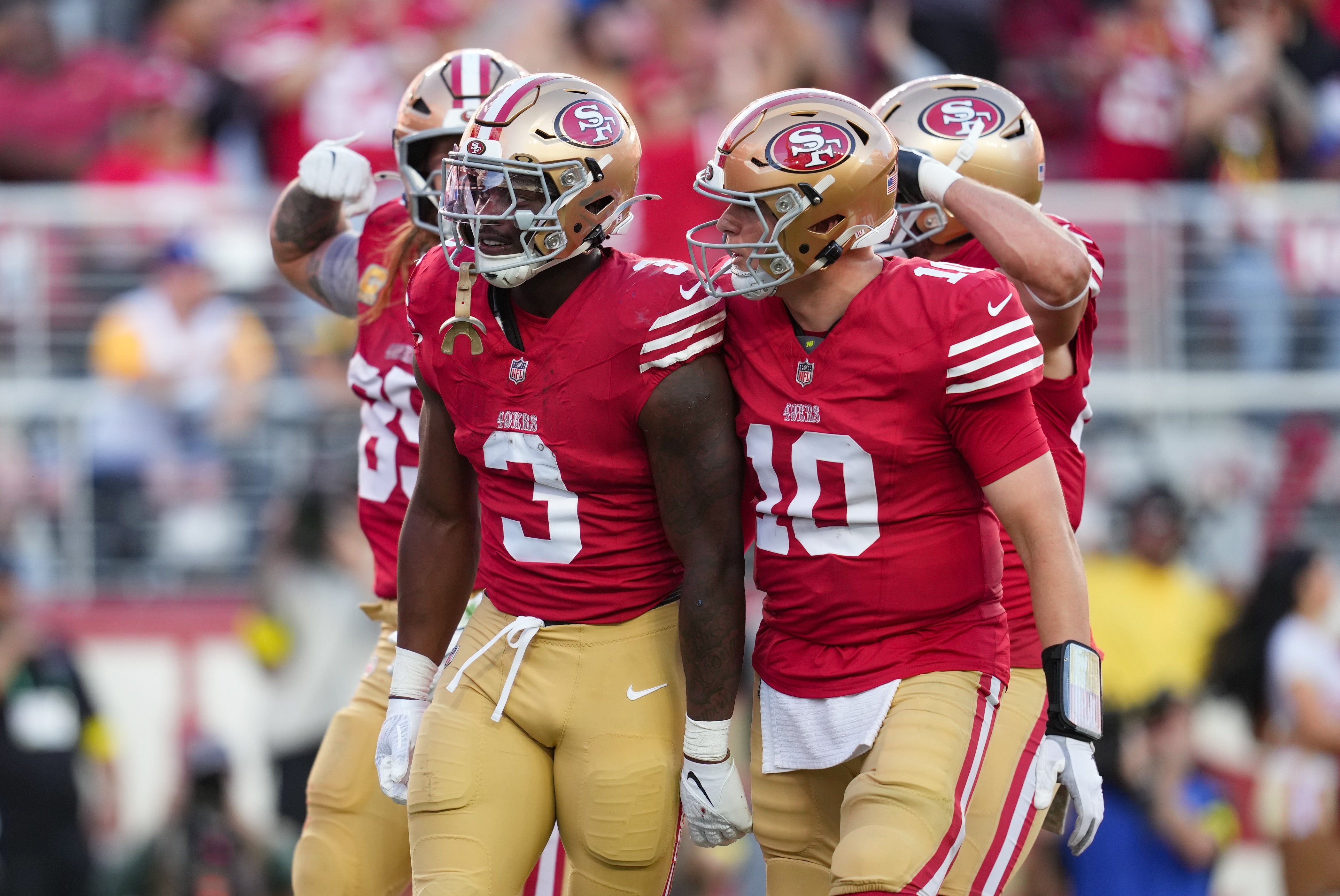 San Francisco 49ers running back Brian Robinson Jr. (3) and quarterback Mac Jones (10) celebrate after a touchdown