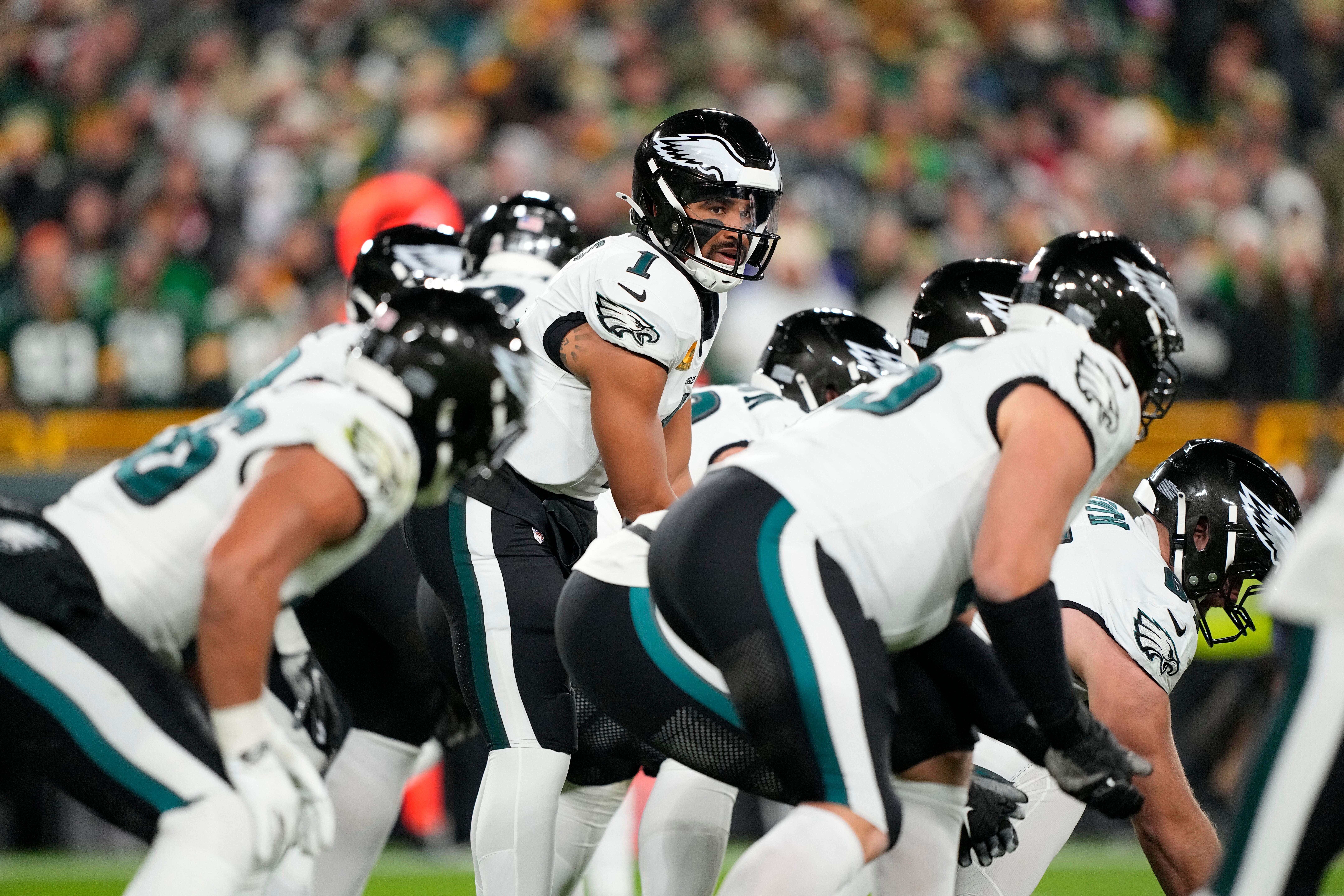Philadelphia Eagles quarterback Jalen Hurts (1) under center against the Green Bay Packers in the first half at Lambeau Field.