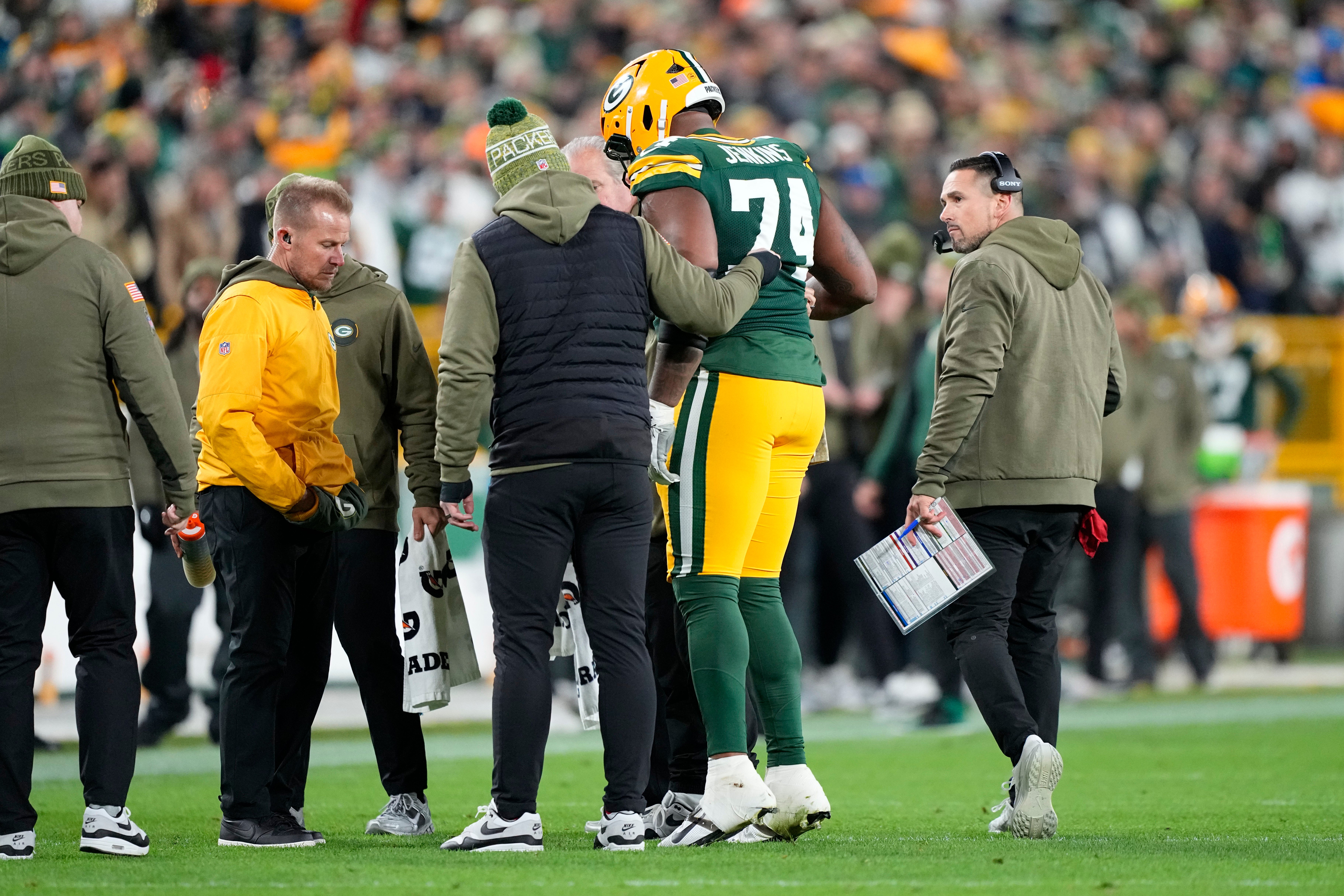 Nov 10, 2025; Green Bay, Wisconsin, USA; Green Bay Packers guard Elgton Jenkins (74) comes off the file with an apparent injury against the Green Bay Packers in the first half at Lambeau Field.