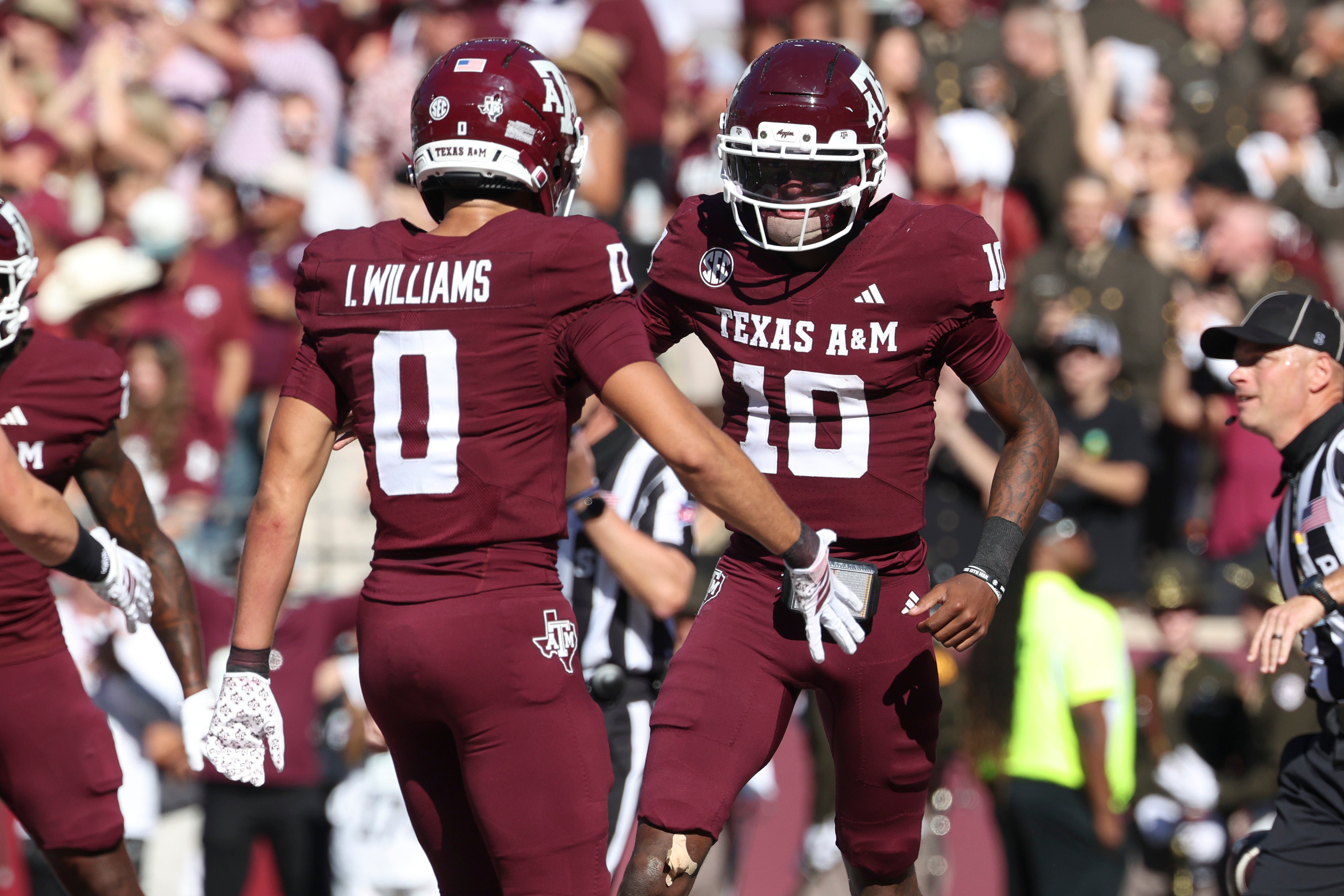 Nov 15, 2025; College Station, Texas, USA; Texas A&M Aggies quarterback Marcel Reed (10) celebrates with wide receiver Izaiah Williams (0) after an Aggies touchdown during the third quarter against the South Carolina Gamecocks at Kyle Field.
