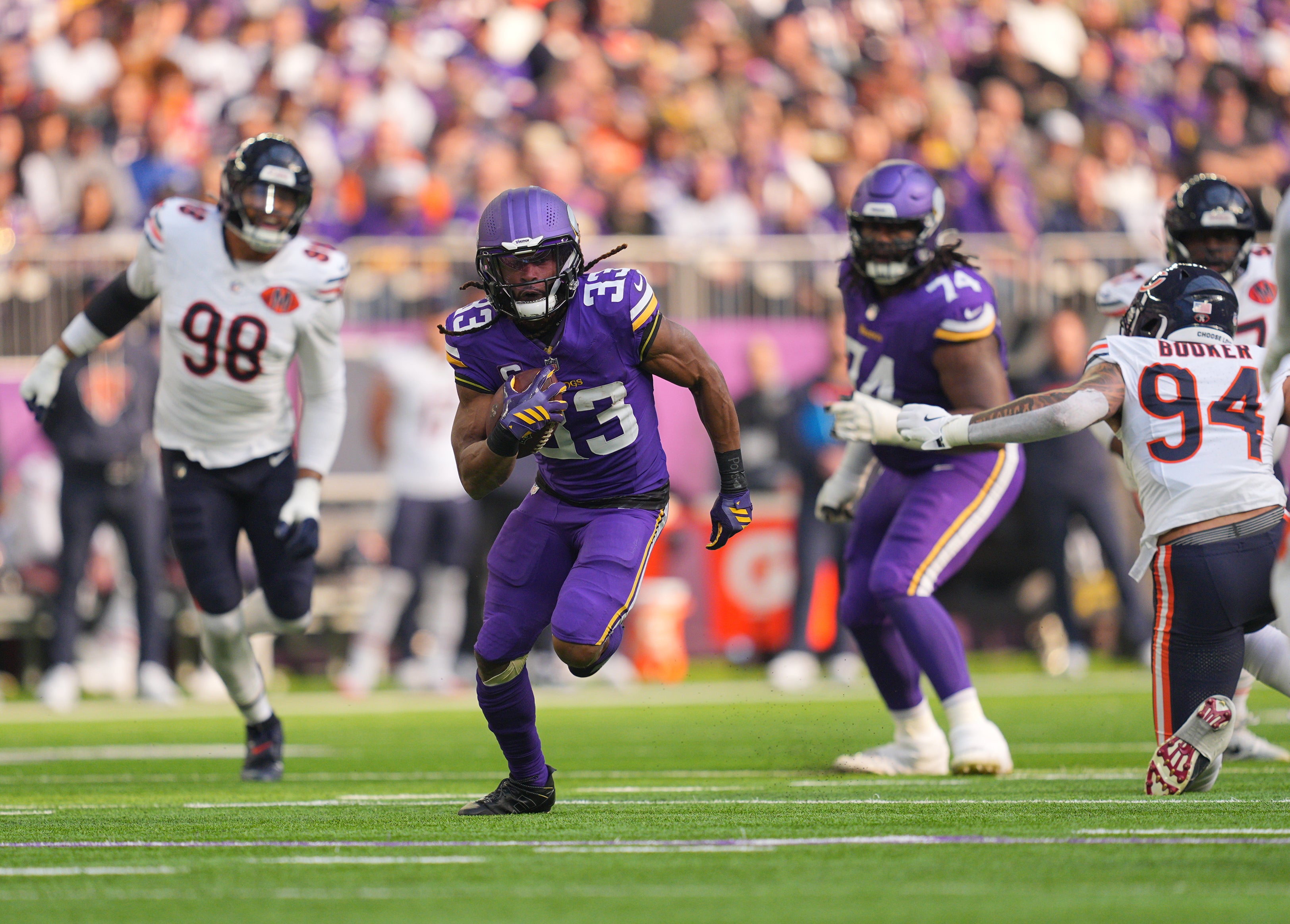 Nov 16, 2025; Minneapolis, Minnesota, USA; Minnesota Vikings running back Aaron Jones (33) runs for a gain during the first quarter against the Chicago Bears at U.S. Bank Stadium.