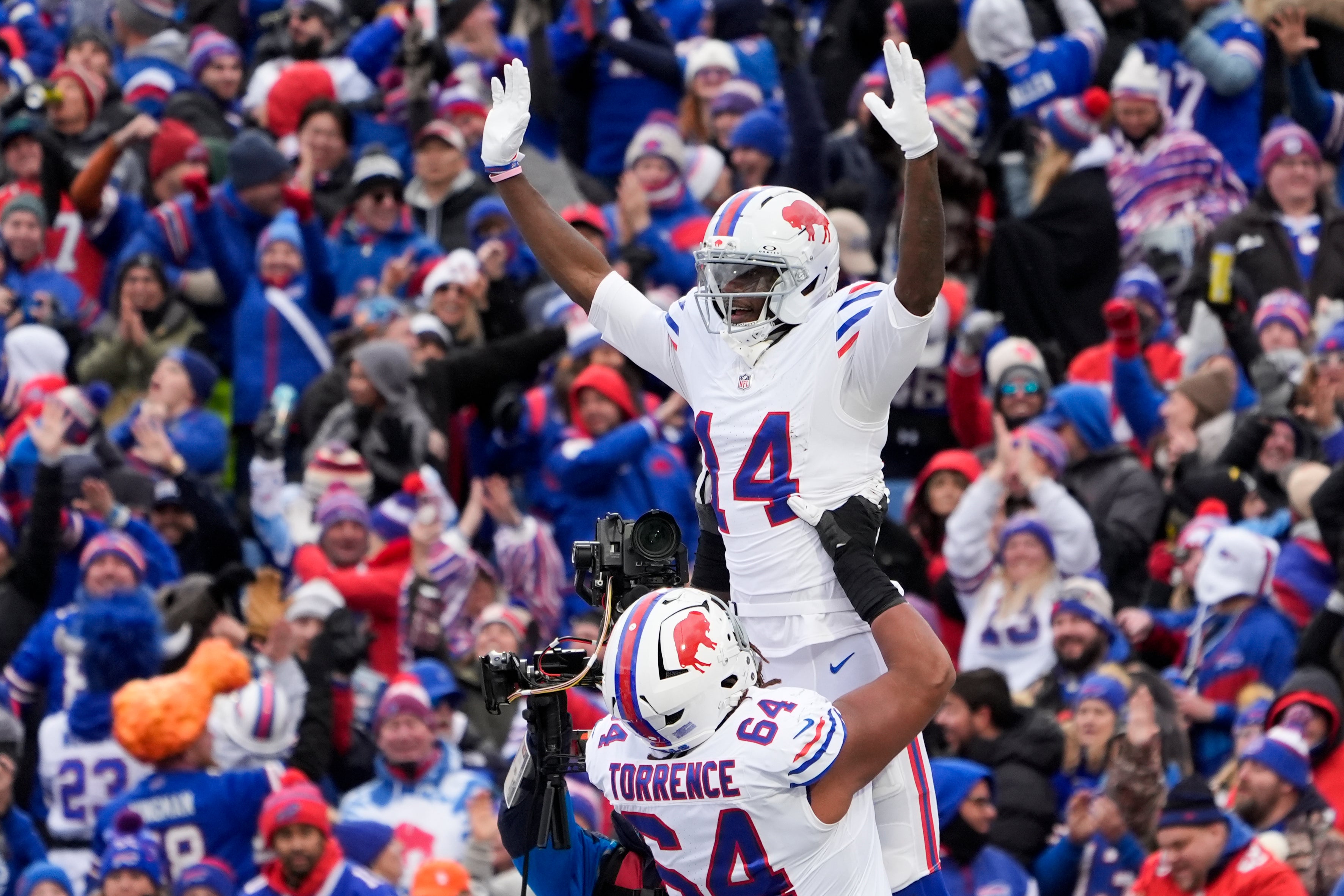 Nov 16, 2025; Orchard Park, New York, USA; Buffalo Bills wide receiver Tyrell Shavers (14) celebrates his touchdown catch against Tampa Bay Buccaneers with guard O’Cyrus Torrence (64) during the first half of the game at Highmark Stadium.