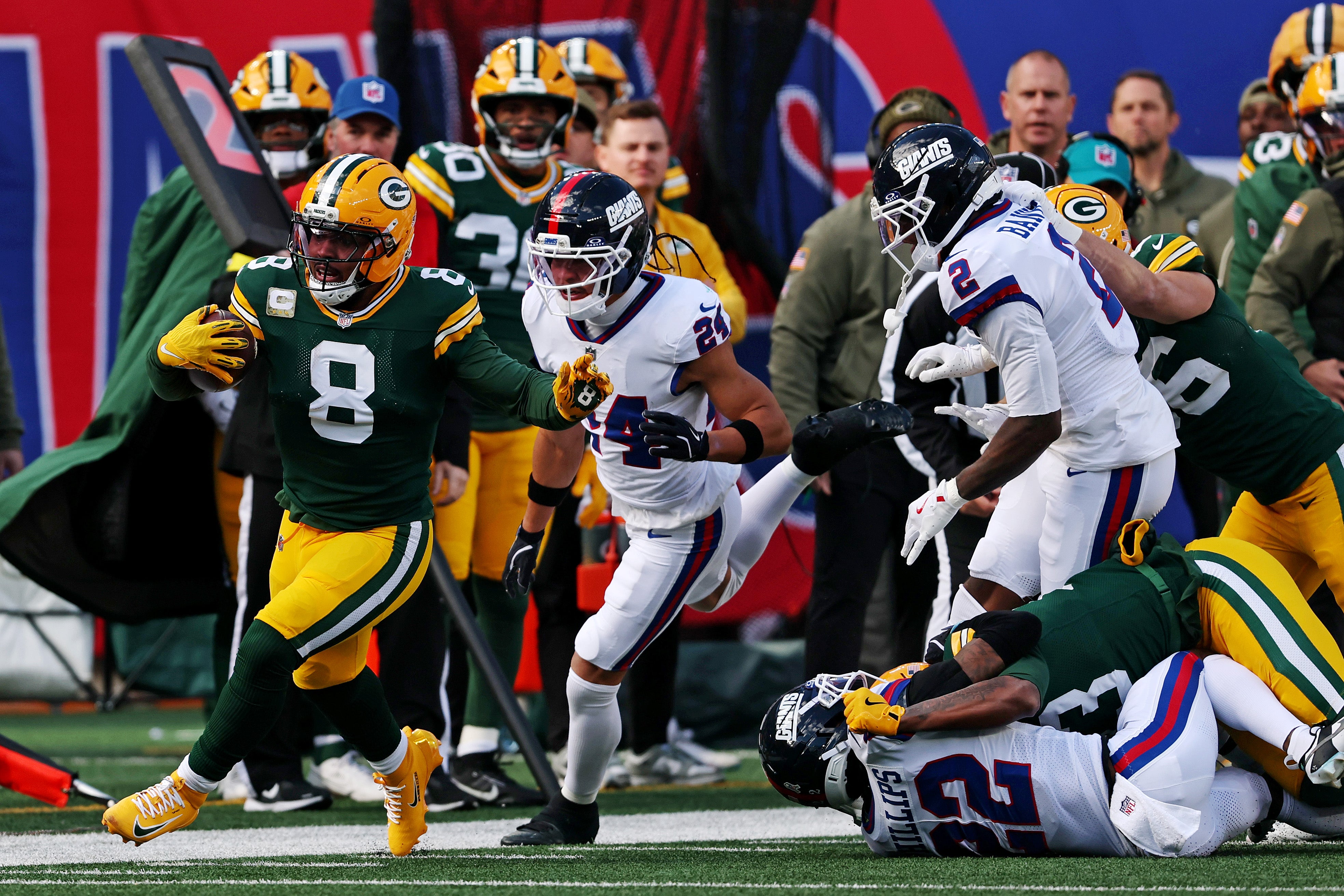 Nov 16, 2025; East Rutherford, New Jersey, USA; Green Bay Packers running back Josh Jacobs (8) runs the ball against New York Giants safety Dane Belton (24) during the first quarter at MetLife Stadium.