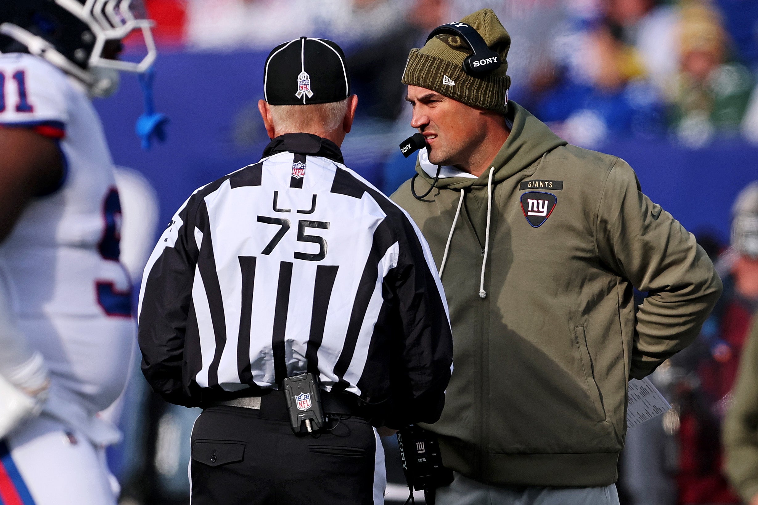 Nov 16, 2025; East Rutherford, New Jersey, USA; New York Giants interim Mike Kafka talks to line judge Mark Stewart (75) during the first quarter against the Green Bay Packers at MetLife Stadium.