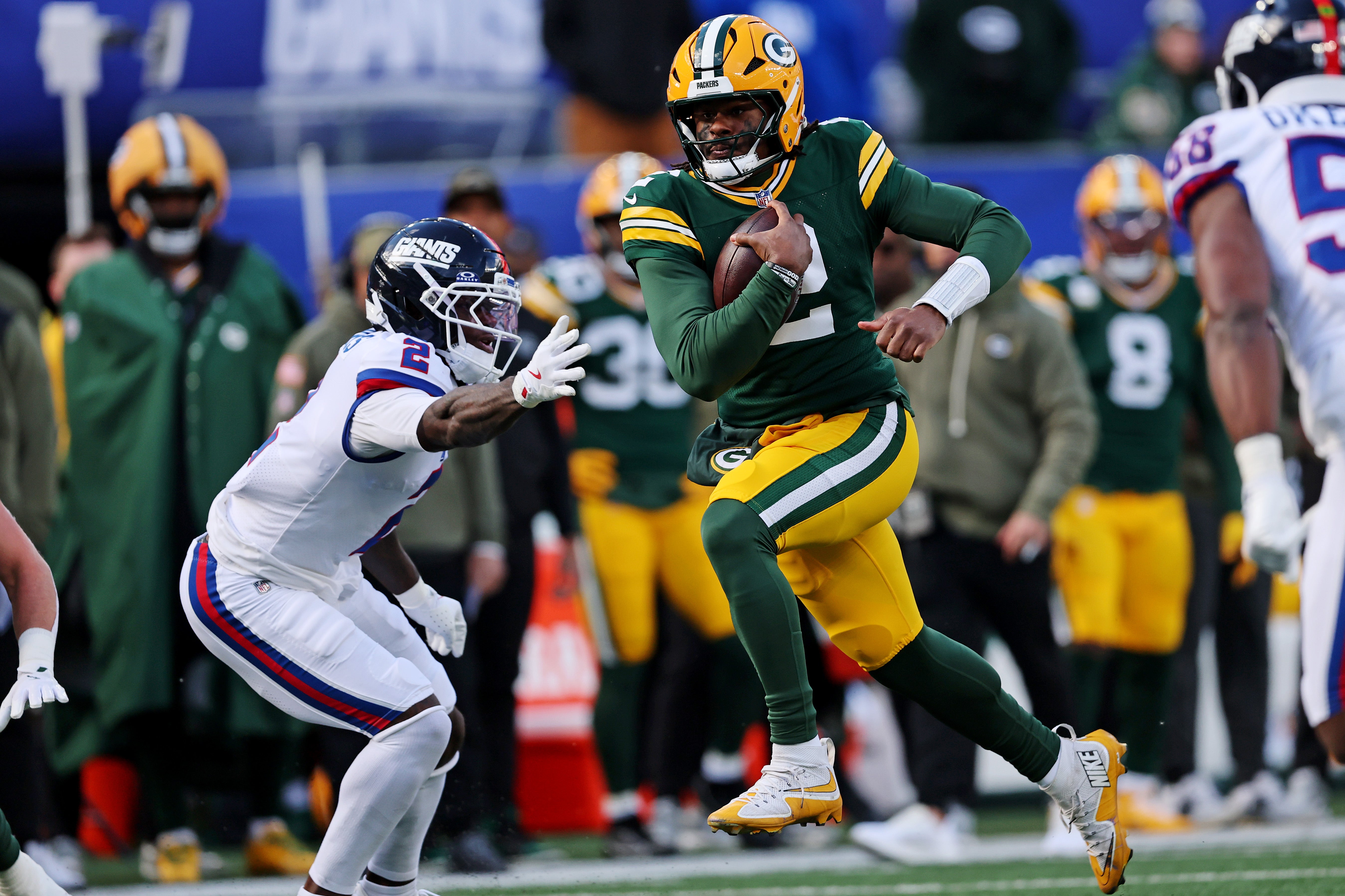 Nov 16, 2025; East Rutherford, New Jersey, USA; Green Bay Packers quarterback Malik Willis (2) runs the ball against New York Giants cornerback Deonte Banks (2) during the second quarter at MetLife Stadium.
