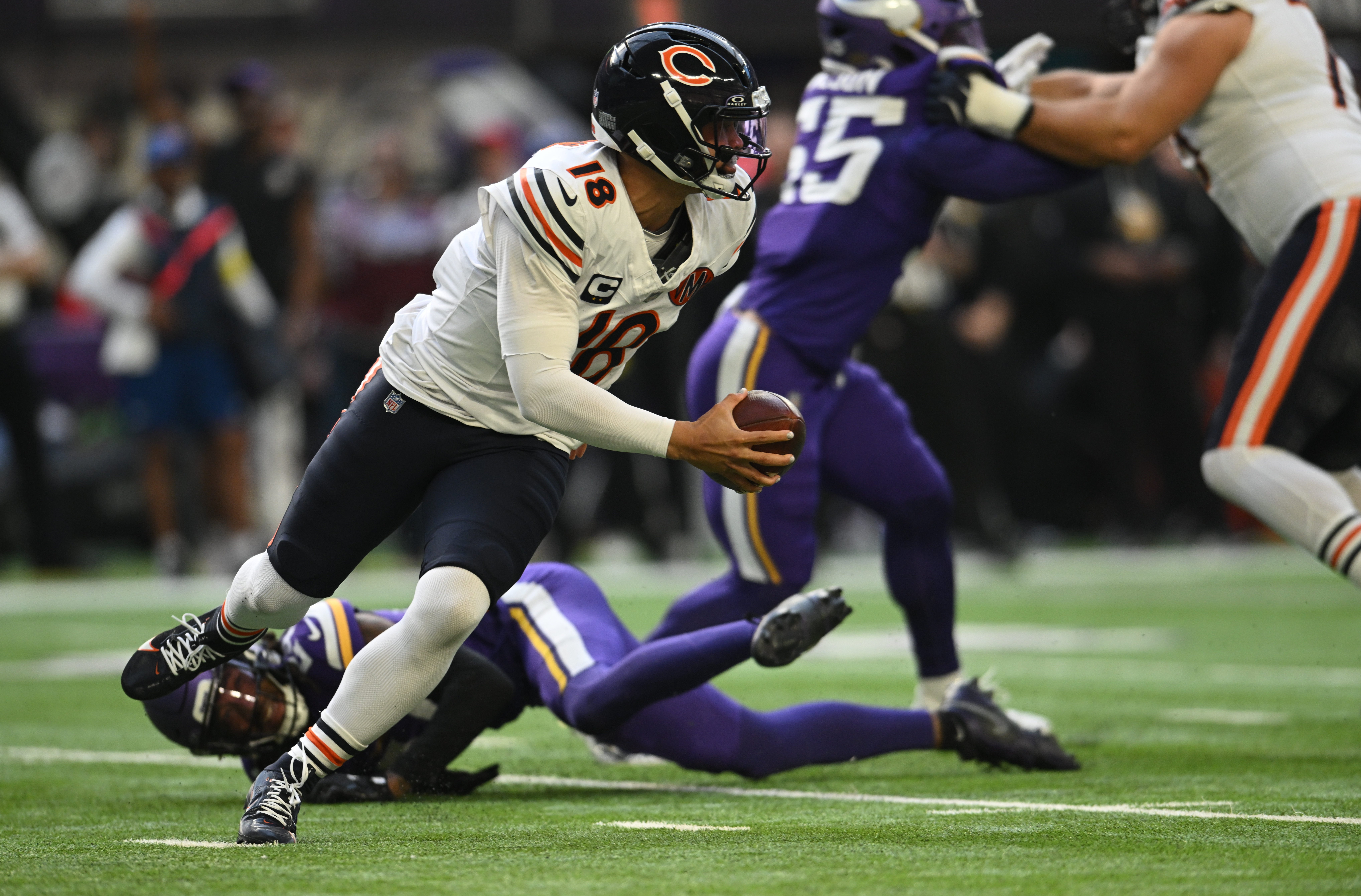 Nov 16, 2025; Minneapolis, Minnesota, USA; Chicago Bears quarterback Caleb Williams (18) scrambles in the pocket during the second quarter against the Minnesota Vikings at U.S. Bank Stadium.