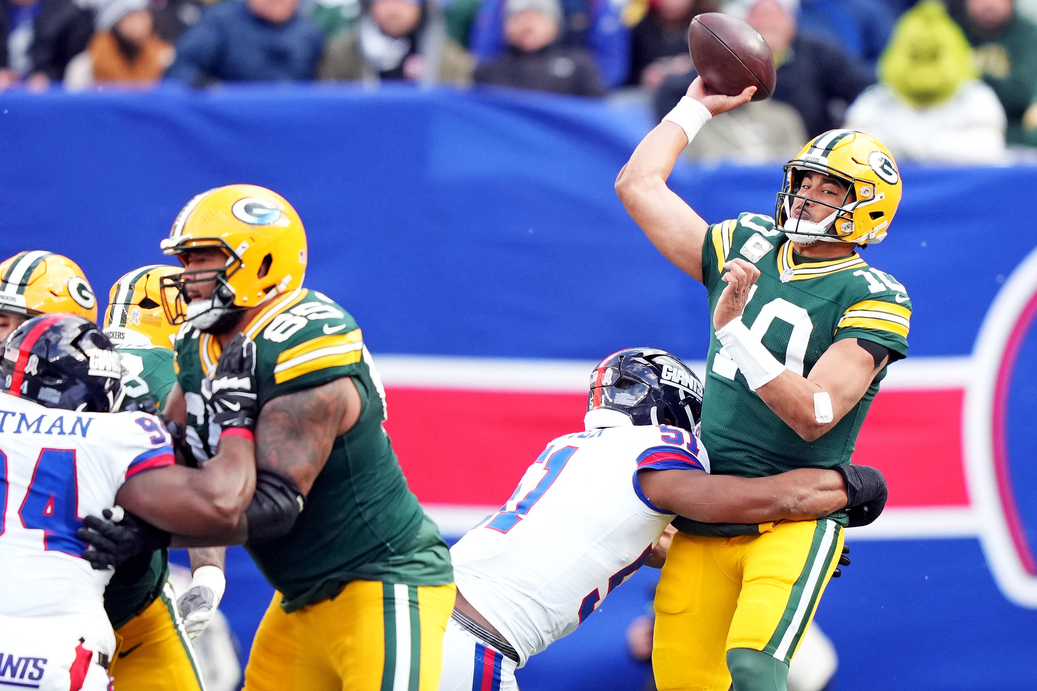 Nov 16, 2025; East Rutherford, New Jersey, USA; Green Bay Packers quarterback Jordan Love (10) throws a pass under pressure from New York Giants linebacker Abdul Carter (51) during the second quarter at MetLife Stadium.