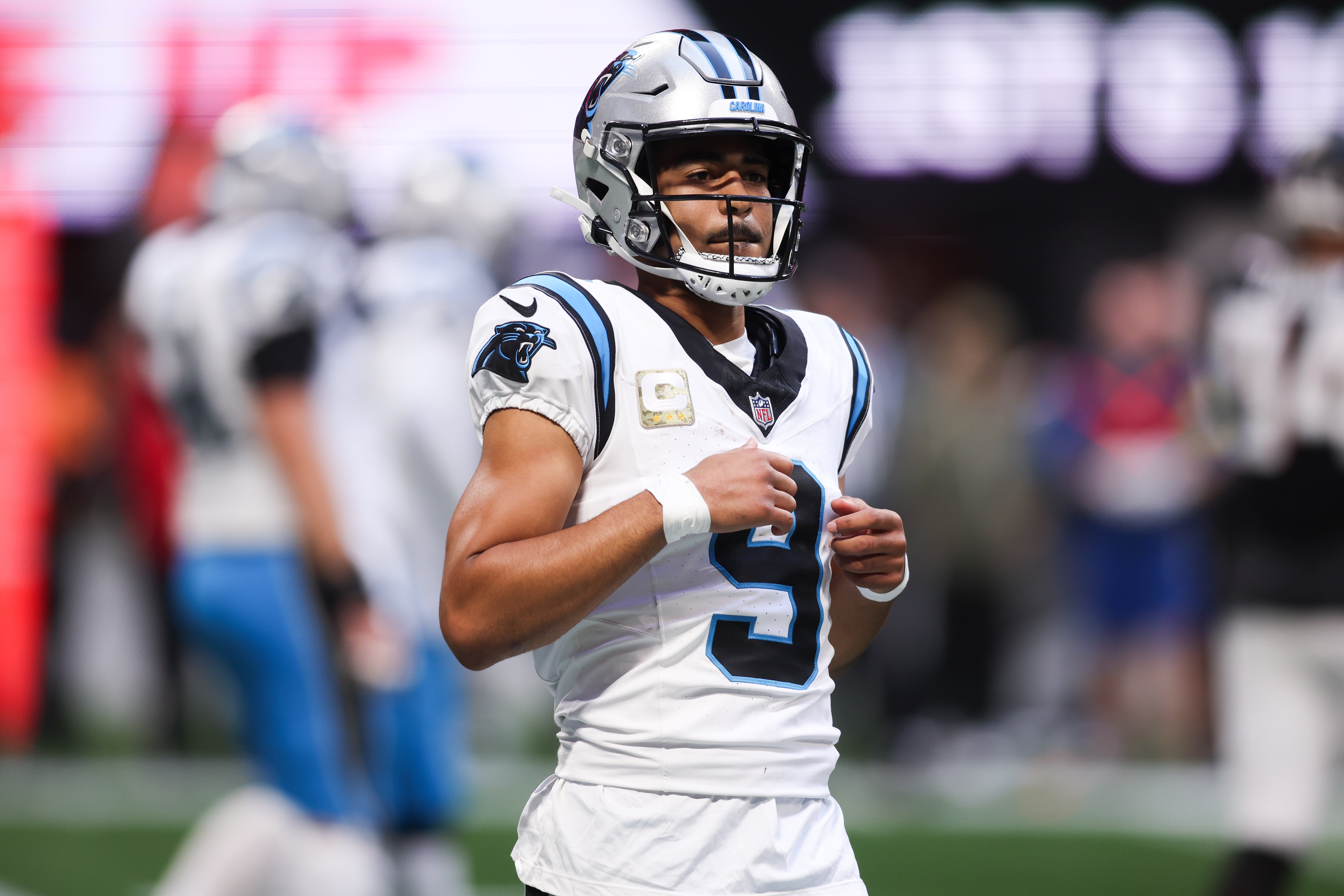 Nov 16, 2025; Atlanta, Georgia, USA; Carolina Panthers quarterback Bryce Young (9) runs off the field in the third quarter against the Atlanta Falcons at Mercedes-Benz Stadium.