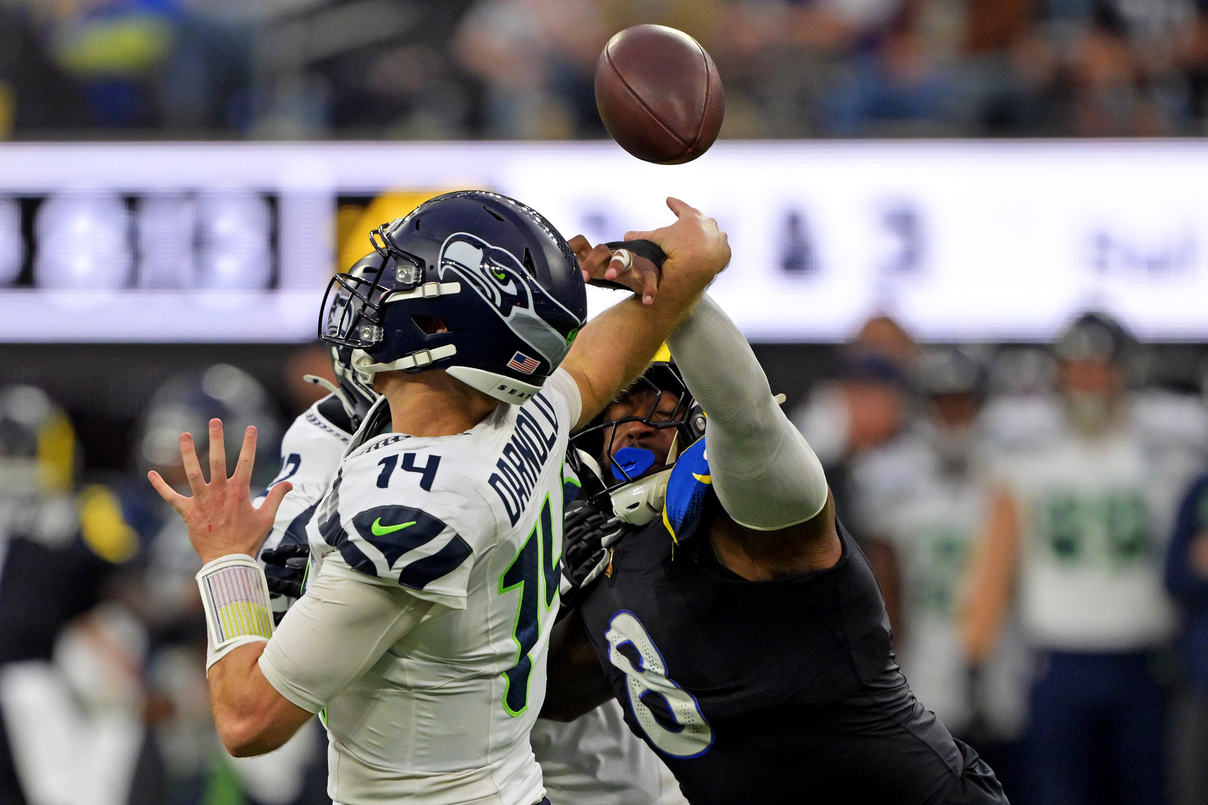 Seahawks QB Sam Darnold has his pass impacted by Rams defender