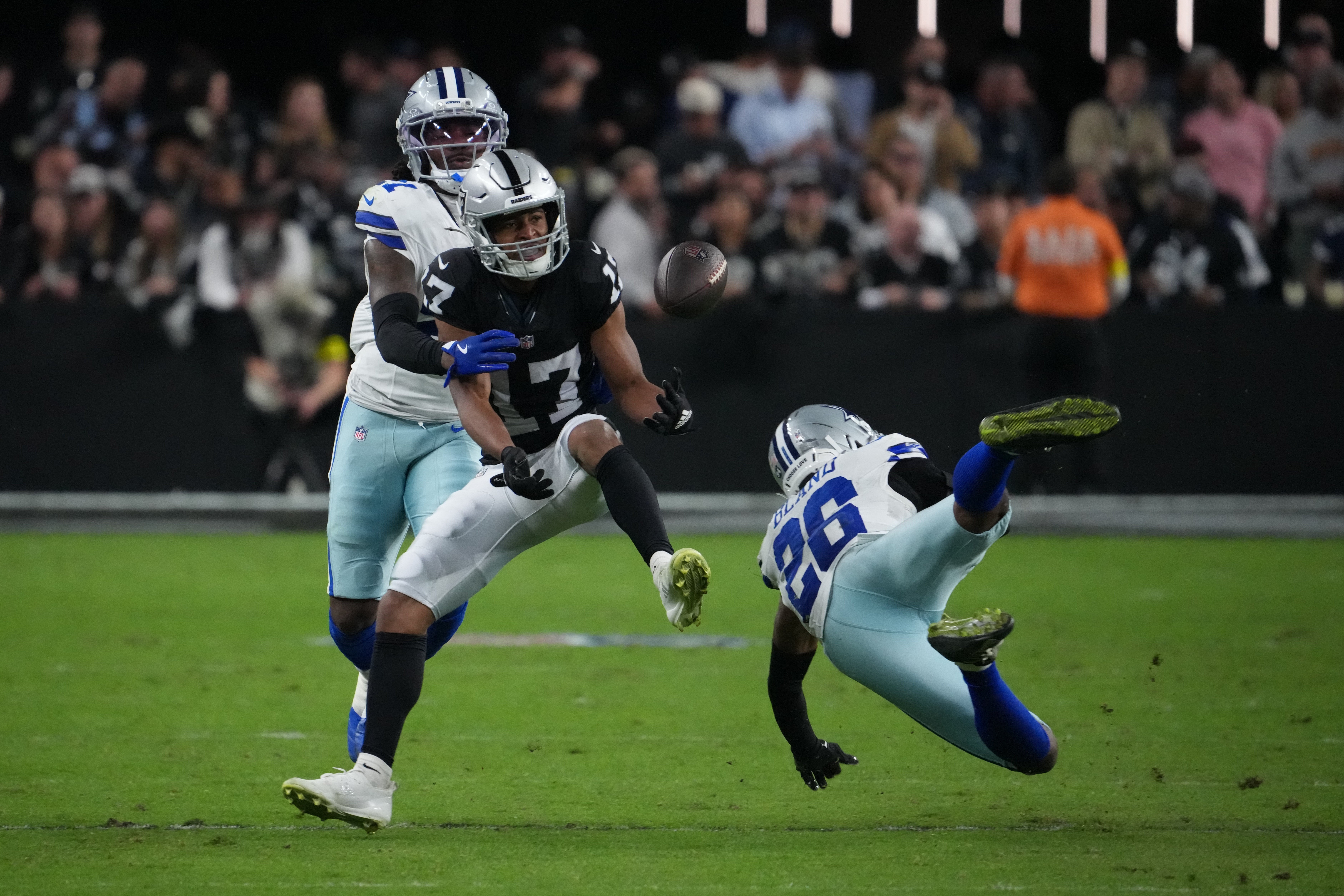 Nov 17, 2025; Paradise, Nevada, USA; Dallas Cowboys cornerback Caelen Carson (21) and cornerback DaRon Bland (26) break up the pass attempt to Las Vegas Raiders wide receiver Tyler Lockett (17) during the first half at Allegiant Stadium.