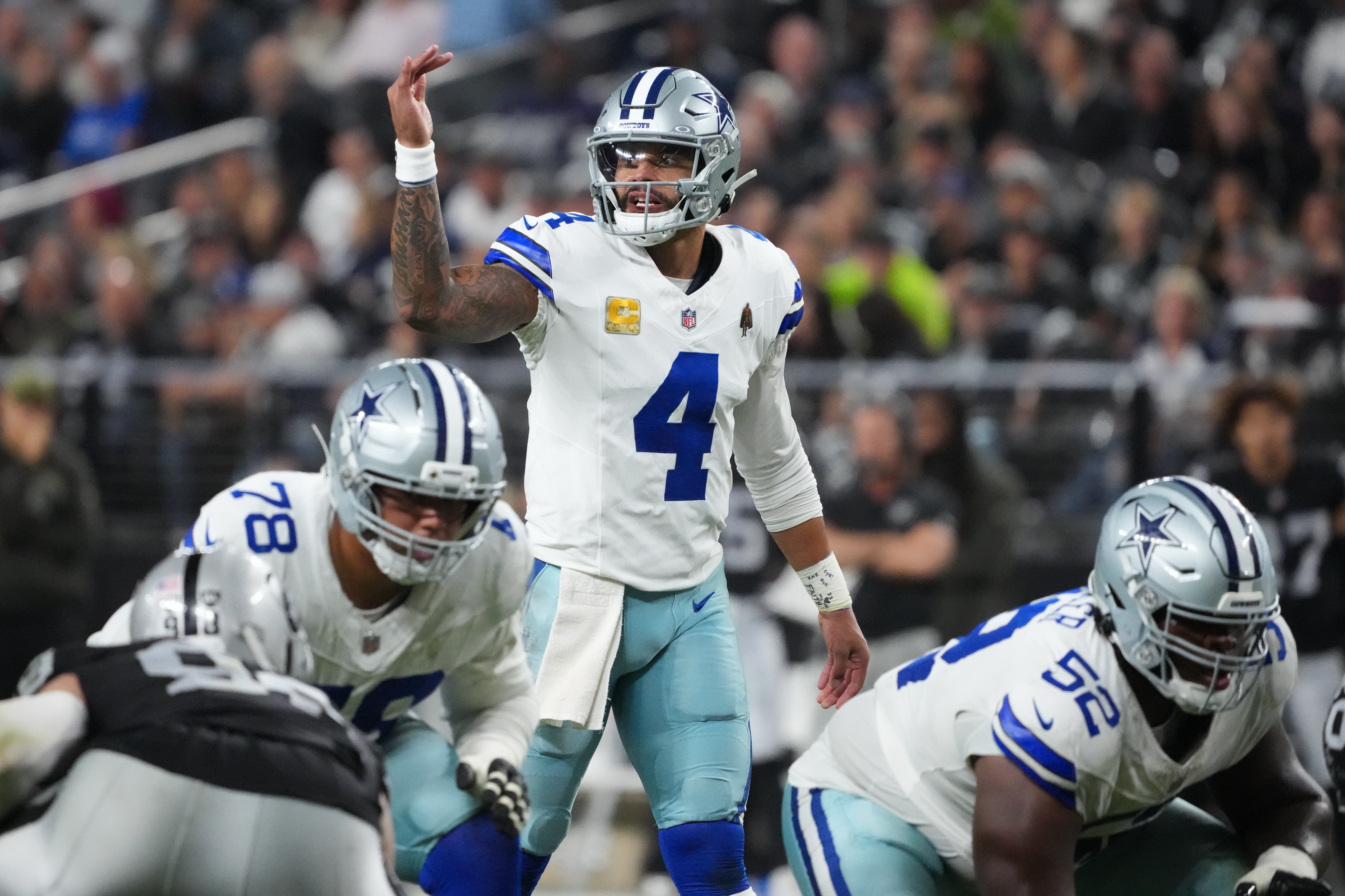 allas Cowboys quarterback Dak Prescott (4) gestures at the line of scrimmage against the Las Vegas Raiders during the second half at Allegiant Stadium.