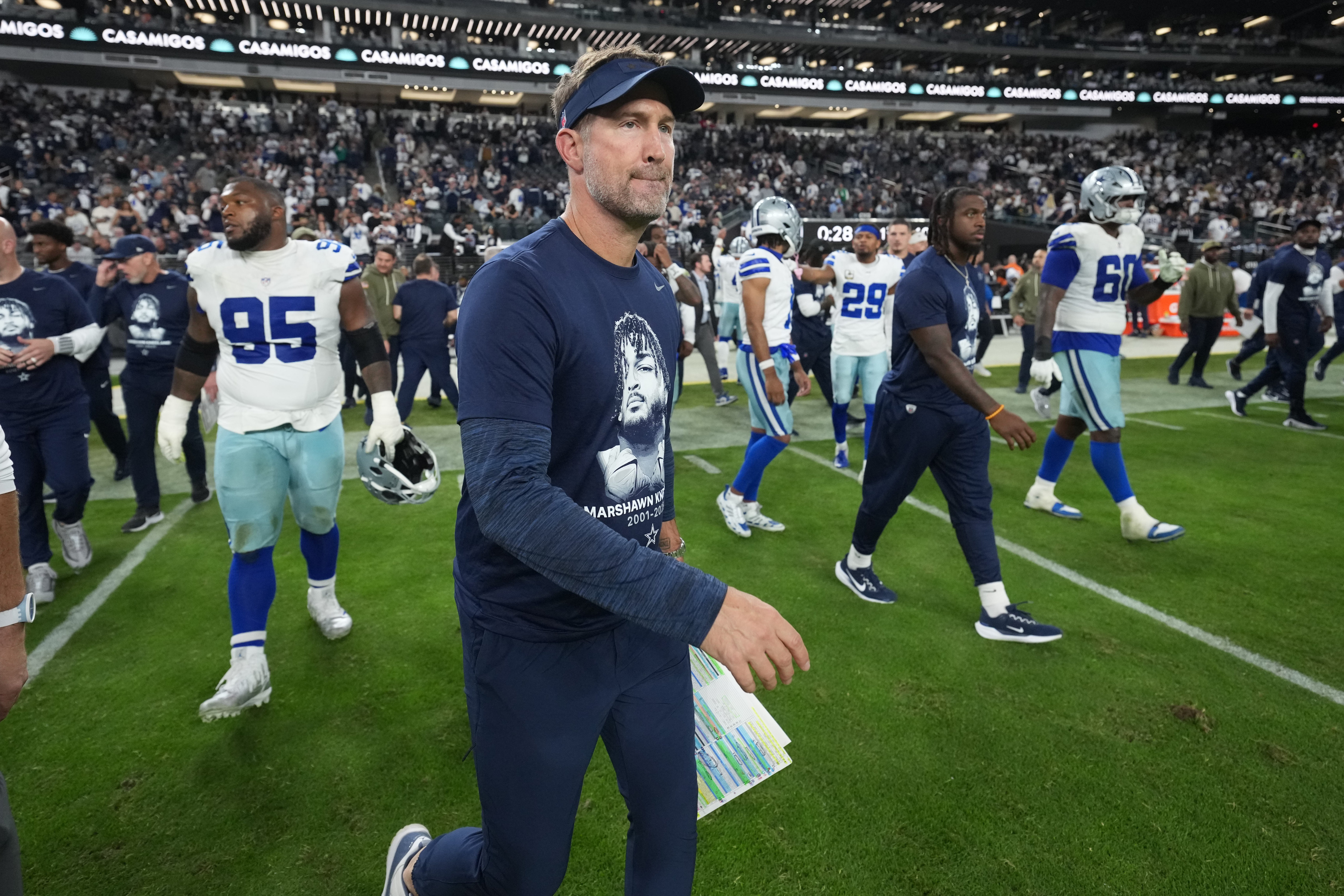Nov 17, 2025; Paradise, Nevada, USA; Dallas Cowboys head coach Brian Schottenheimer walks to midfield following a game against the Las Vegas Raiders at Allegiant Stadium.