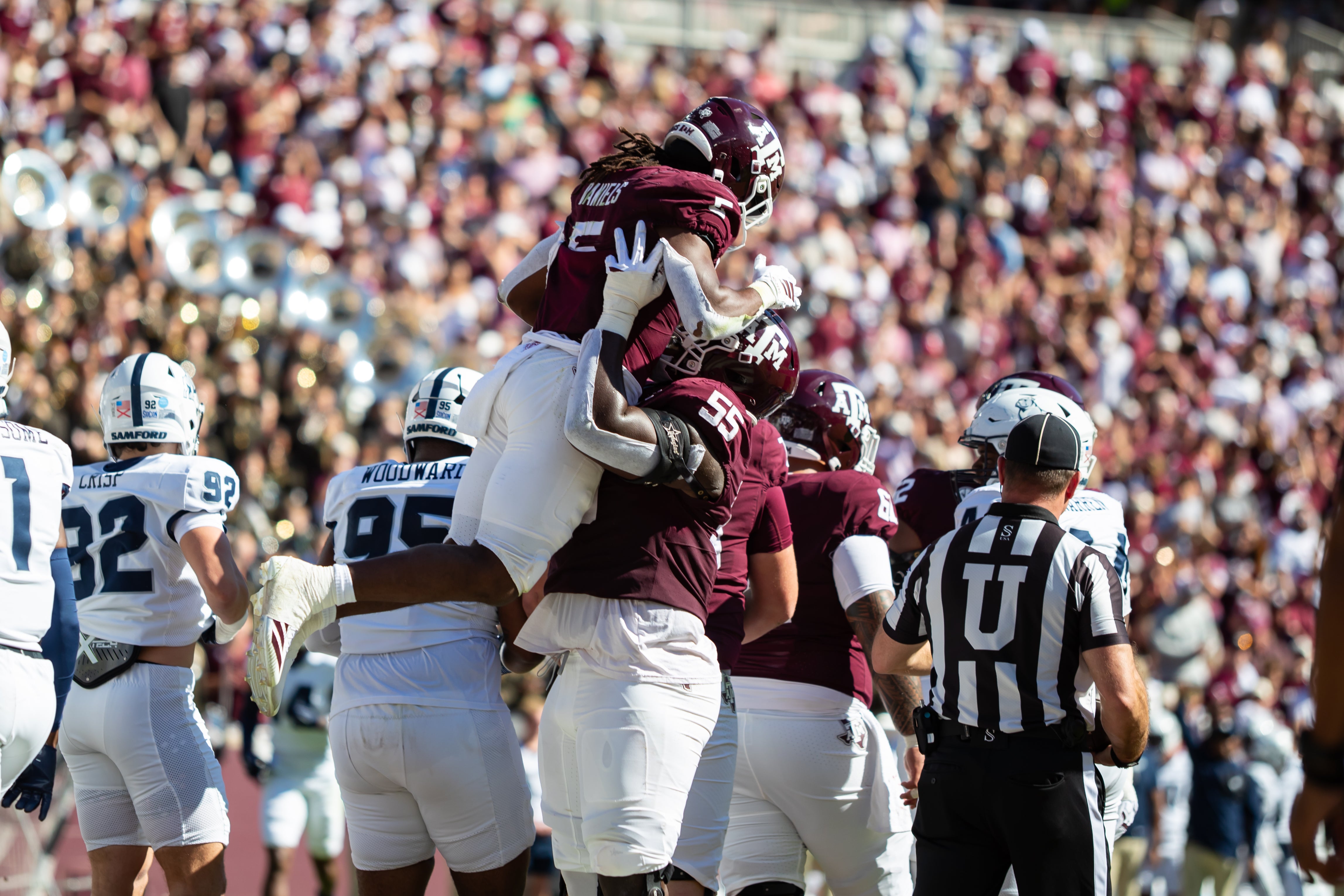 Nov 22, 2025; College Station, Texas, USA; Texas A&M Aggies running back Amari Daniels (5) is lift into the air by offensive lineman Ar'maj Reed-Adams (55) in the first half of a game against the Samford Bulldogs at Kyle Field.