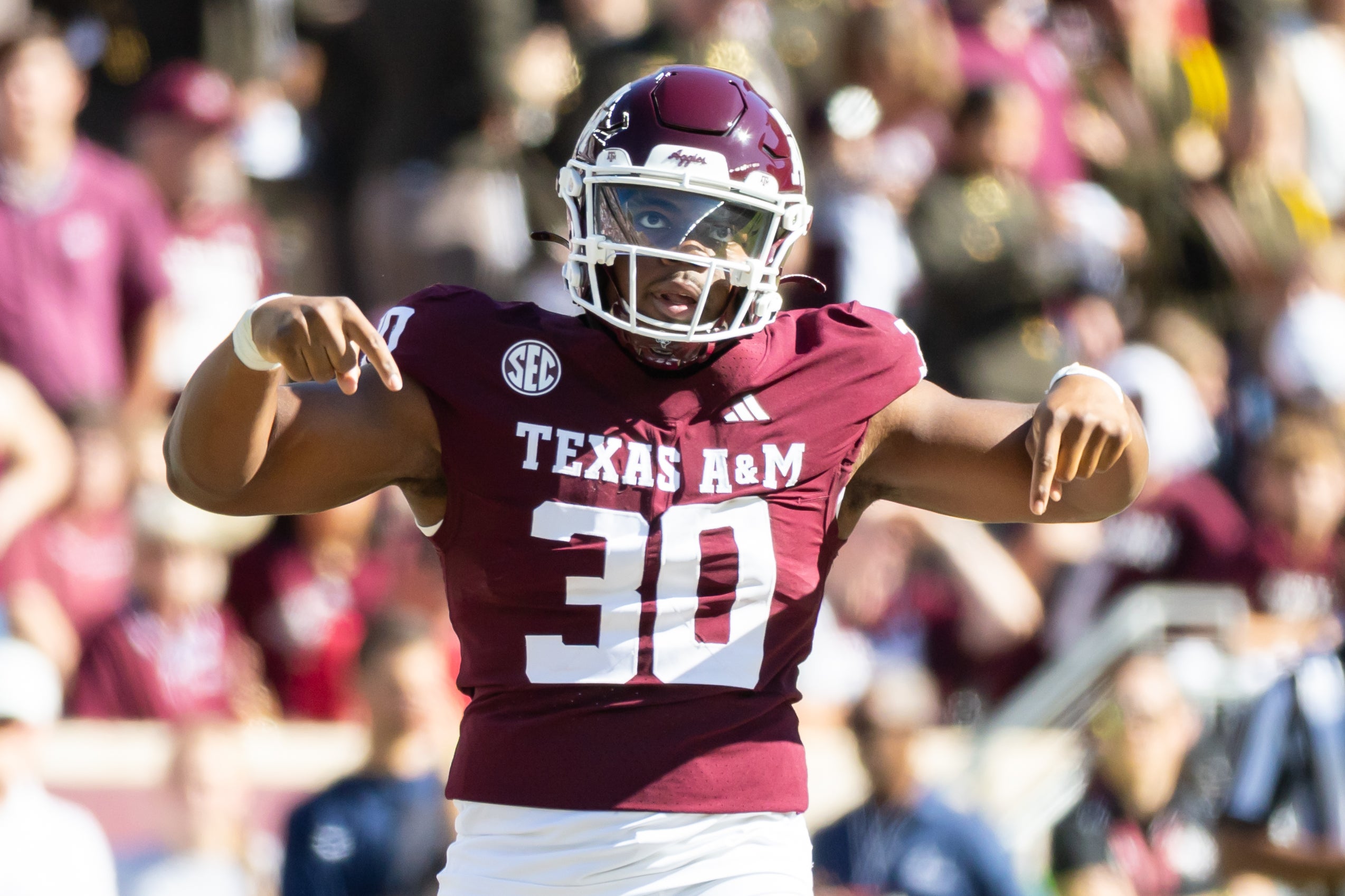 Nov 22, 2025; College Station, Texas, USA; Texas A&M Aggies defensive end Solomon Williams (30) celebrates after a tackle in the second half of a game agains the Samford Bulldogs at Kyle Field.