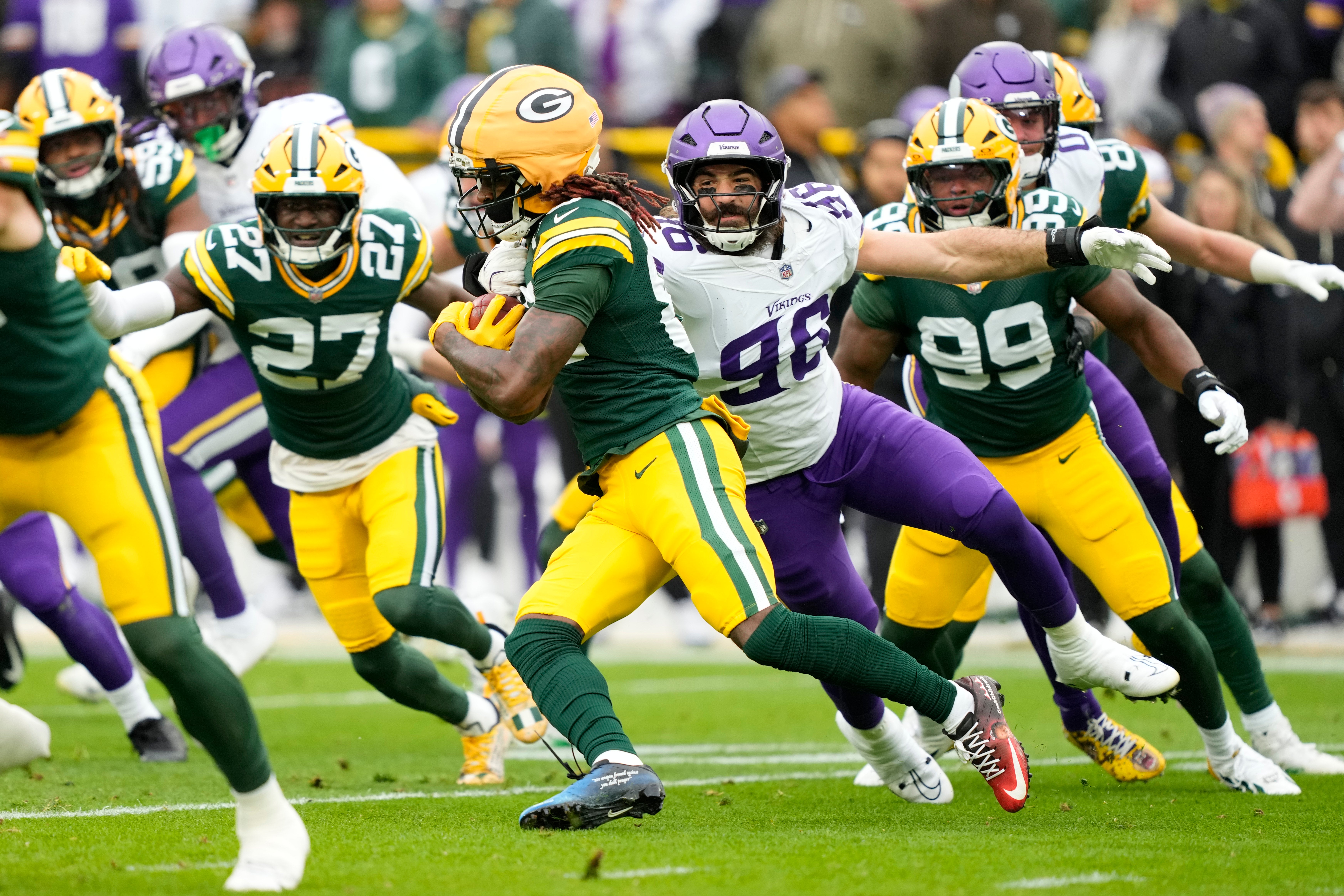 Nov 23, 2025; Green Bay, Wisconsin, USA; Green Bay Packers wide receiver Savion Williams (83) is tackled by Minnesota Vikings linebacker Tyler Batty (96) on a punt return during the first half at Lambeau Field.