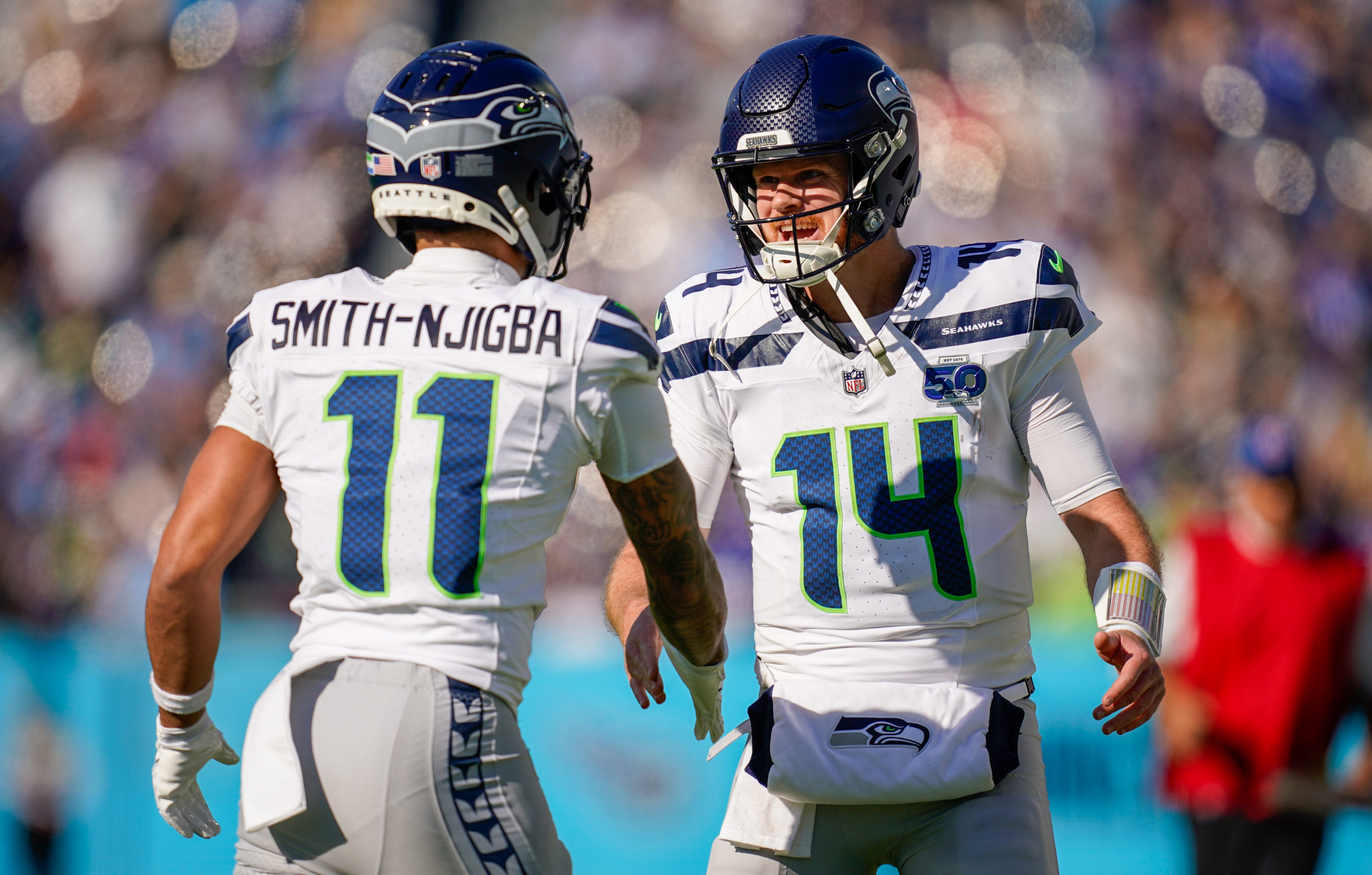 Seattle Seahawks wide receiver Jaxon Smith-Njigba (11) celebrates his touchdown with quarterback Sam Darnold (14) during the second quarter against the Tennessee Titans at Nissan Stadium in Nashville, Tenn., Sunday, Nov. 23, 2025.