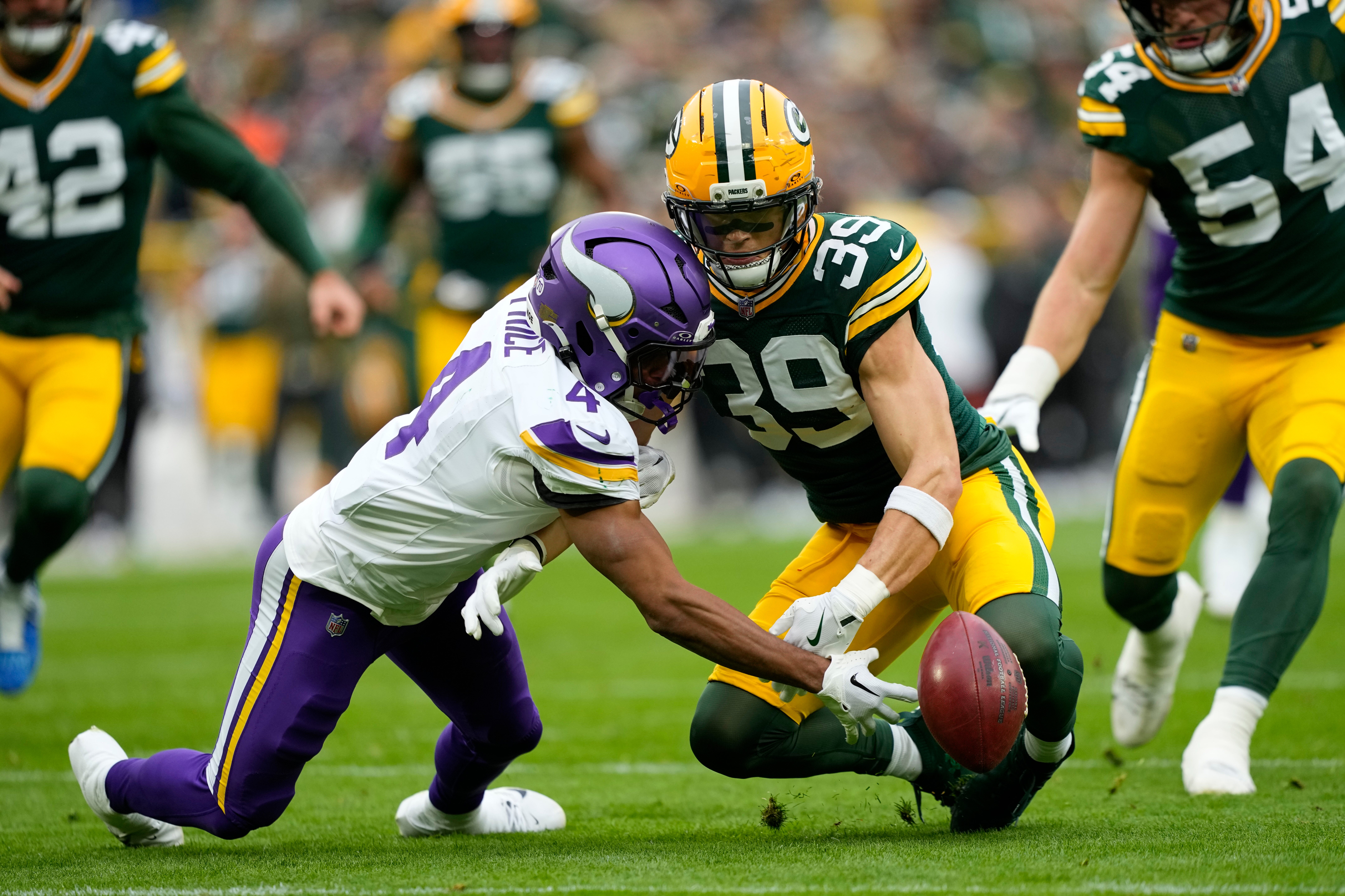 Nov 23, 2025; Green Bay, Wisconsin, USA; Minnesota Vikings wide receiver Myles Price (4) muffs the punt return as Green Bay Packers safety Zayne Anderson (39) defends during the second half at Lambeau Field.