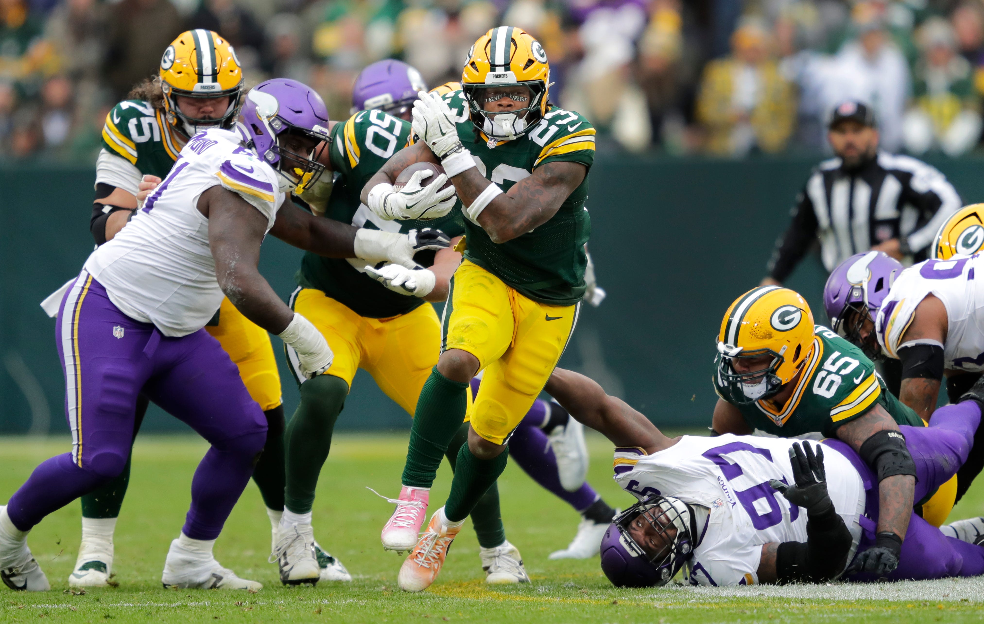 Green Bay Packers running back Emanuel Wilson (23) runs for a first down against the Minnesota Vikings in the third quarter during their football game Sunday, November 23, 2025, at Lambeau Field in Green Bay, Wisconsin.