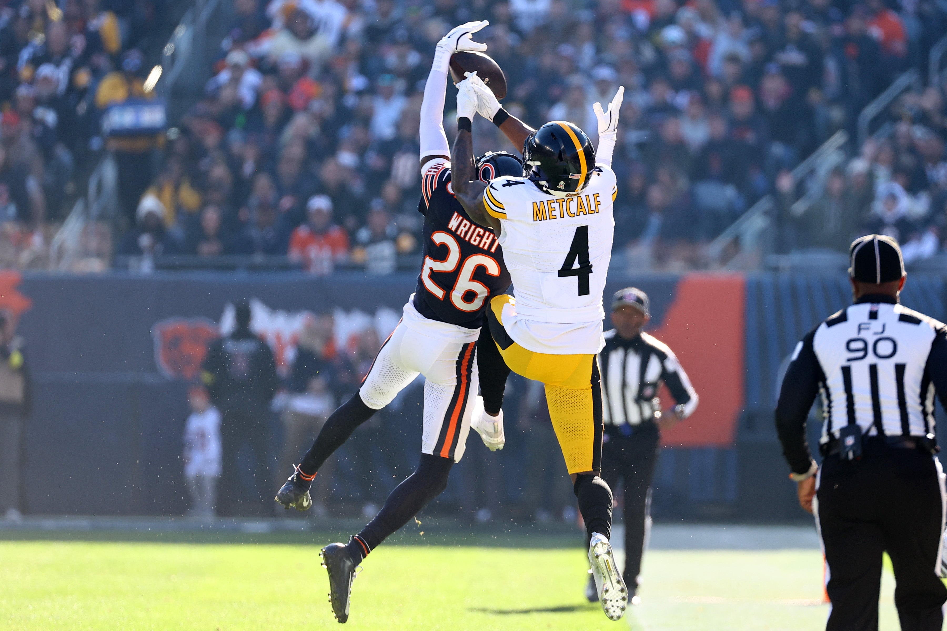 Nov 23, 2025; Chicago, Illinois, USA; Chicago Bears cornerback Nahshon Wright (26) intercepts a pass against Pittsburgh Steelers wide receiver DK Metcalf (4) during the first half at Soldier Field.