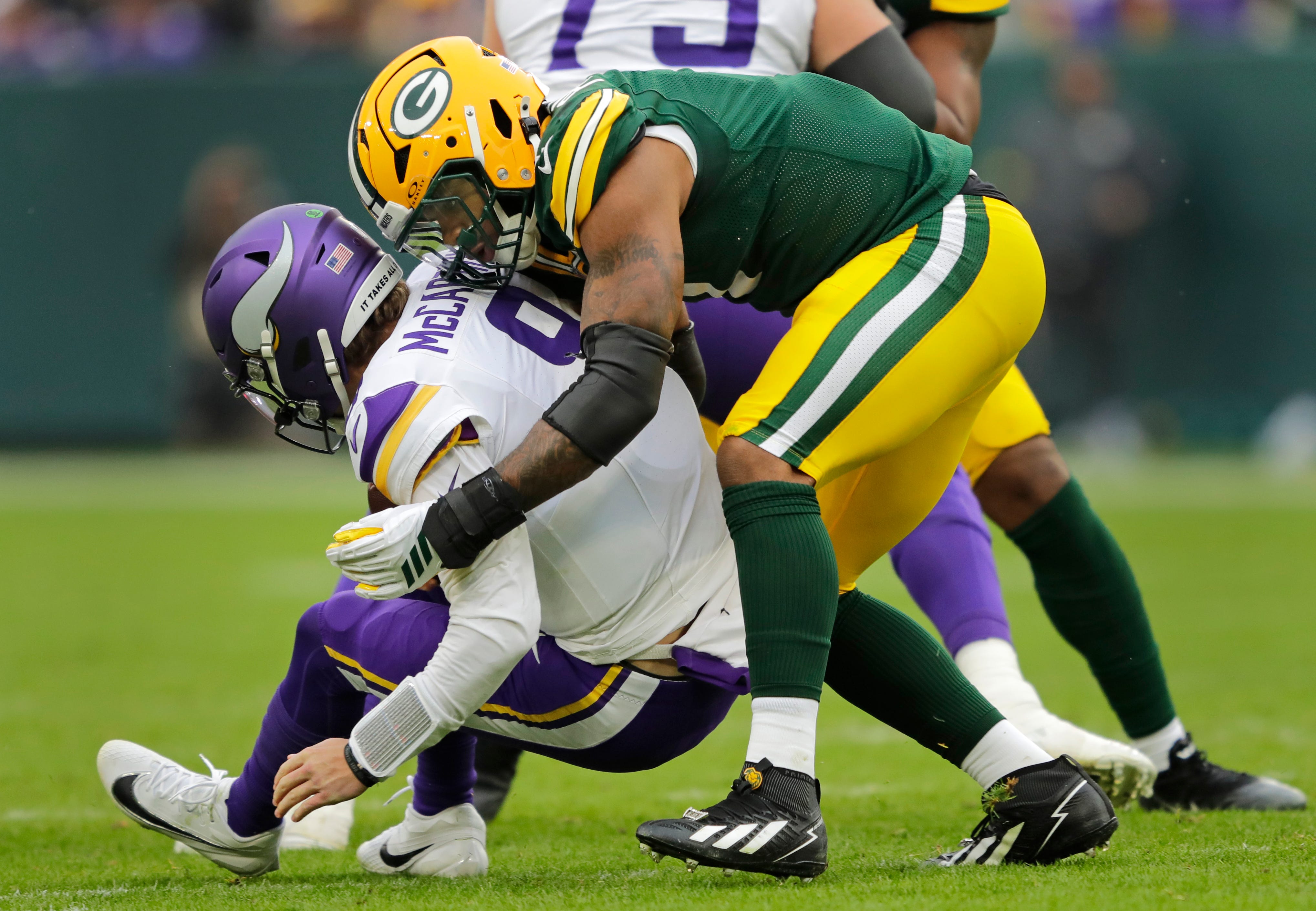 Green Bay Packers defensive end Micah Parsons (1) sacks Minnesota Vikings quarterback J.J. McCarthy (9) during their football game Sunday, November 23, 2025, at Lambeau Field in Green Bay, Wisconsin.
